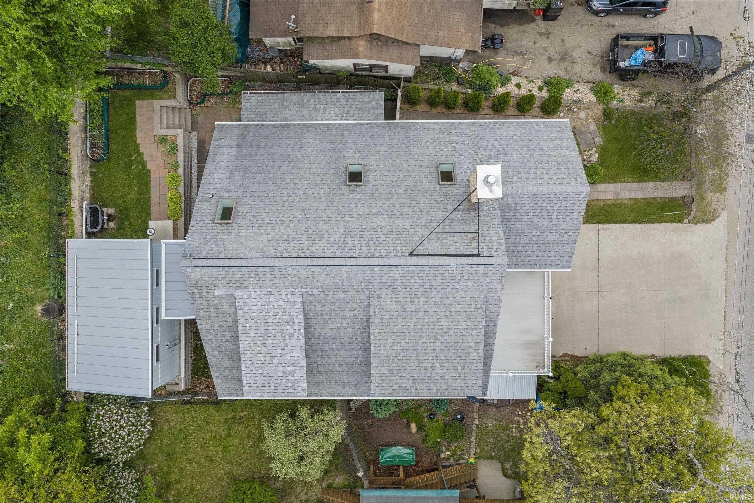 Asphalt shingle roof with multiple skylights and a large chimney