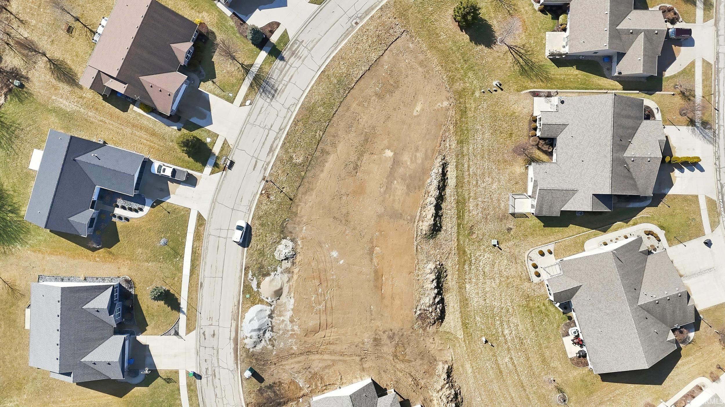 Aerial view of property and surrounding area featuring nearby suburban area