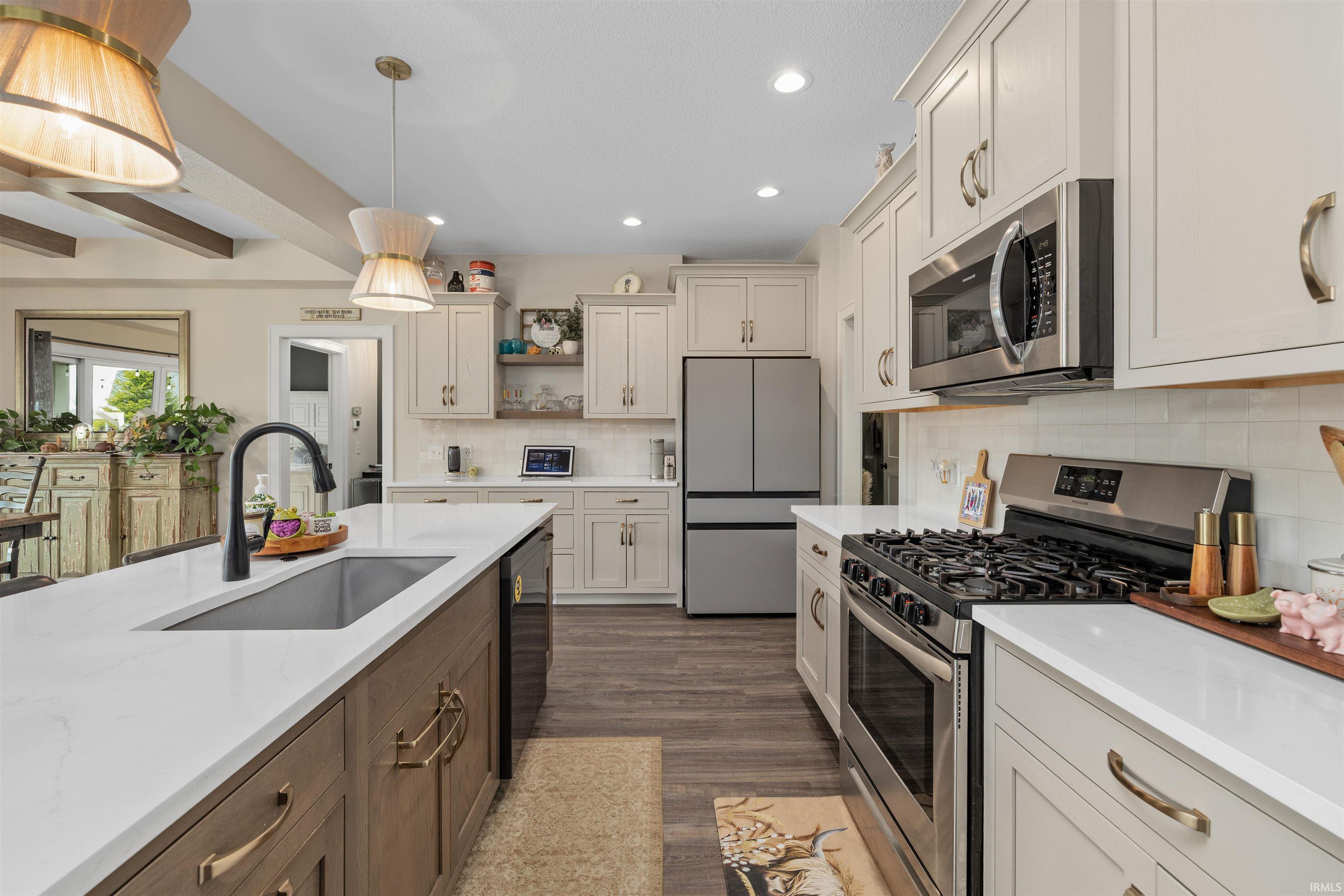Dual tone kitchen with stainless steel appliances, dual tone cabinets, open shelves, light wood-type flooring, and light stone counters