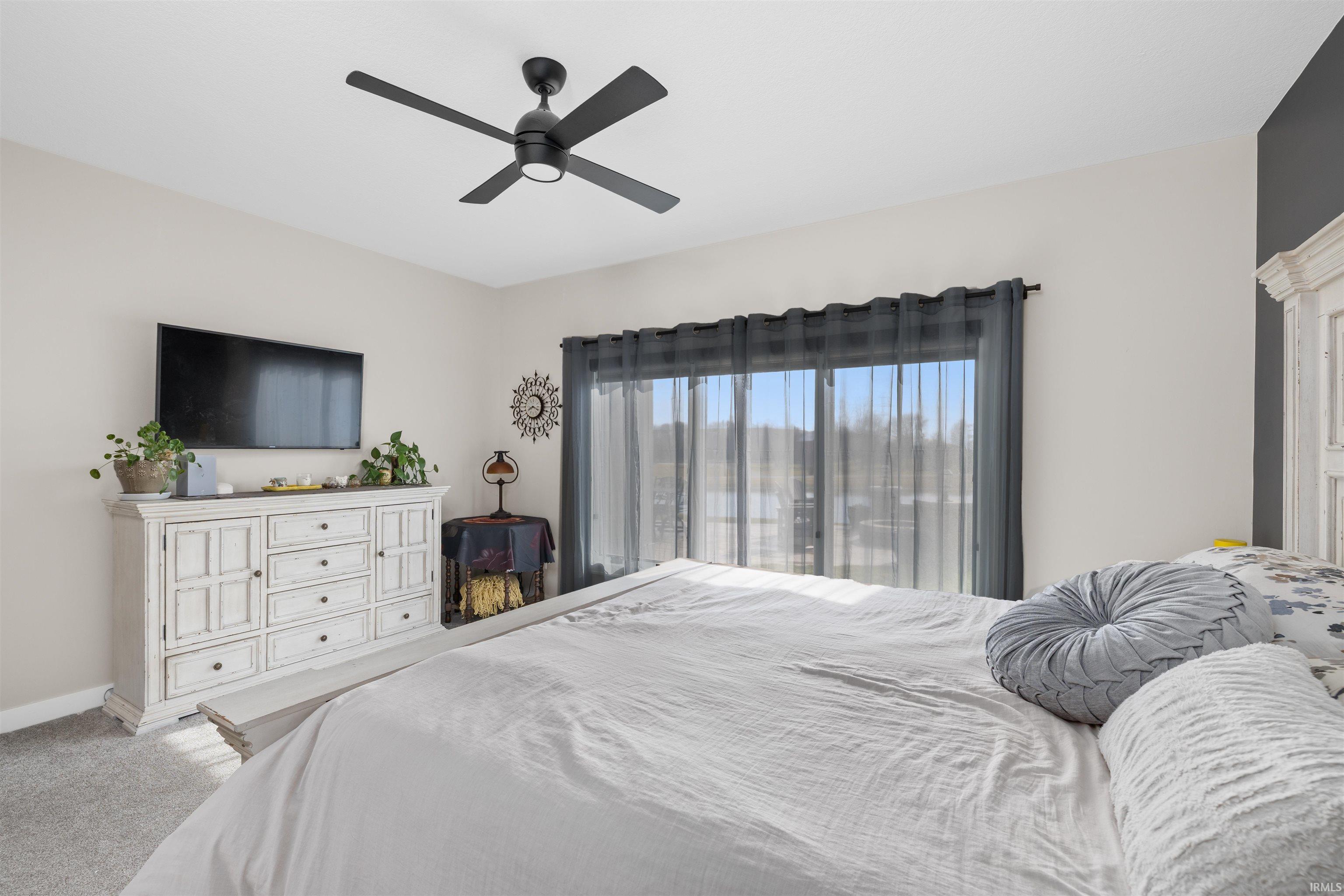 Bedroom featuring carpet flooring and a ceiling fan