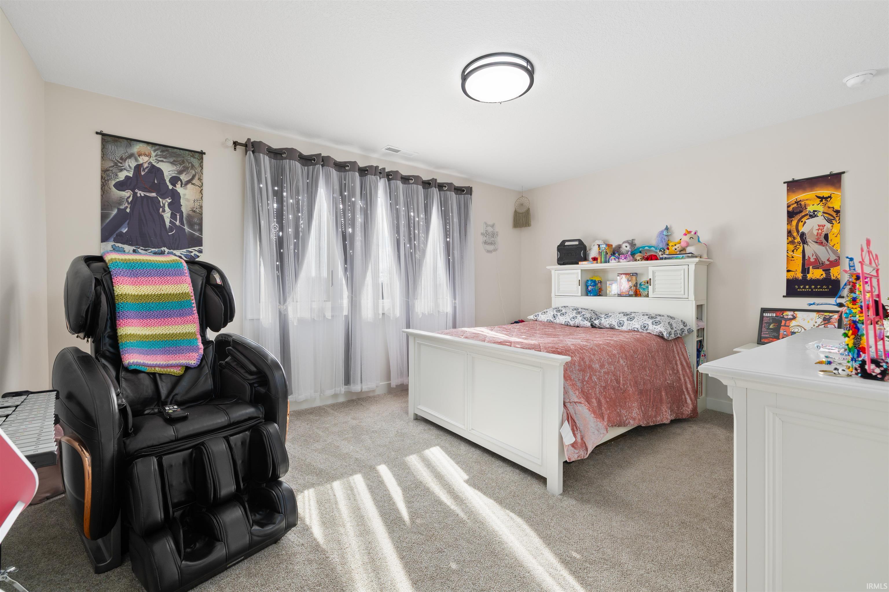 Bedroom featuring light colored carpet