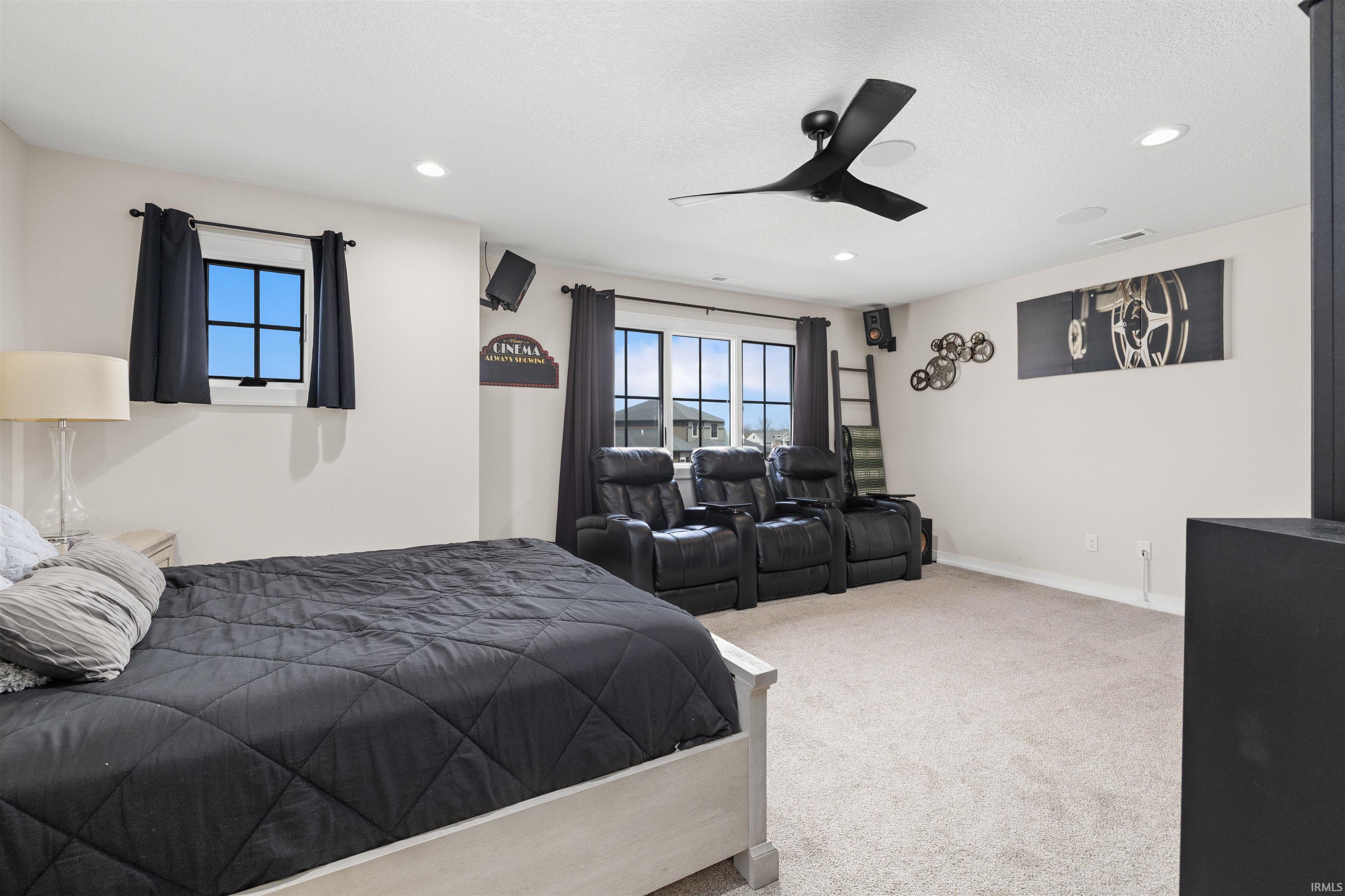 Carpeted bedroom with ceiling fan and recessed lighting