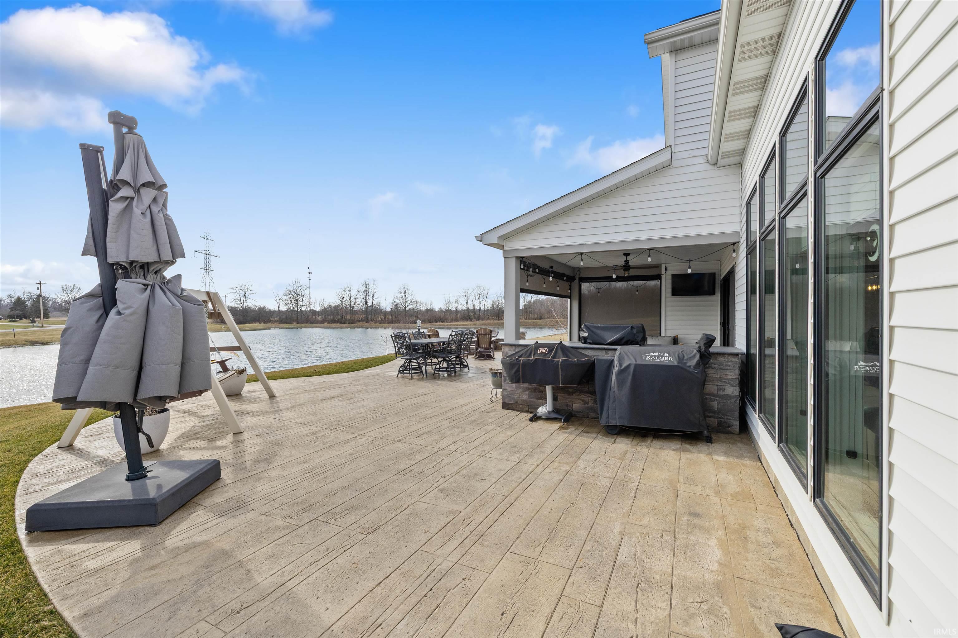 Deck with a patio area and a grill