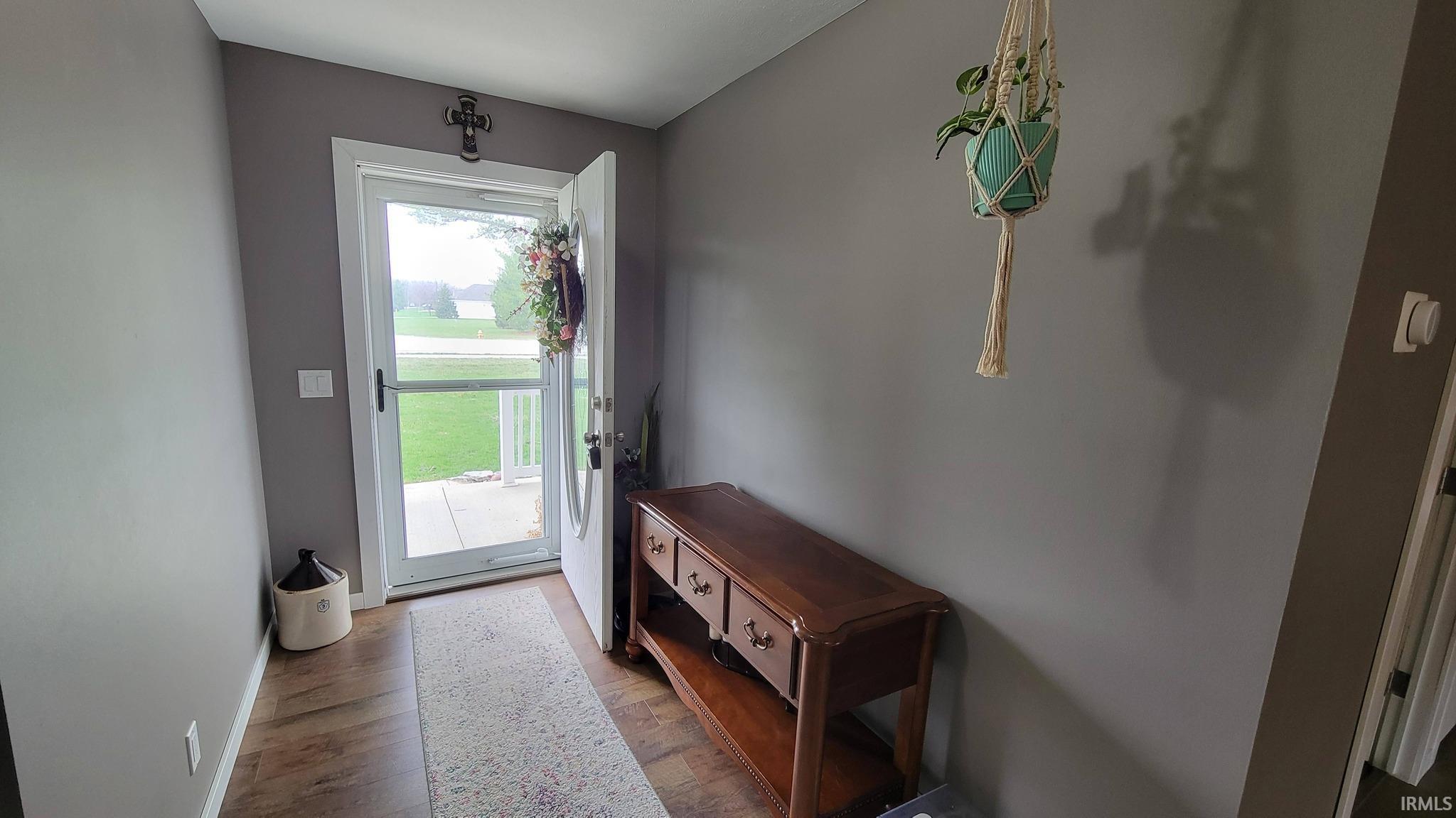 Entryway featuring wood finished floors and baseboards
