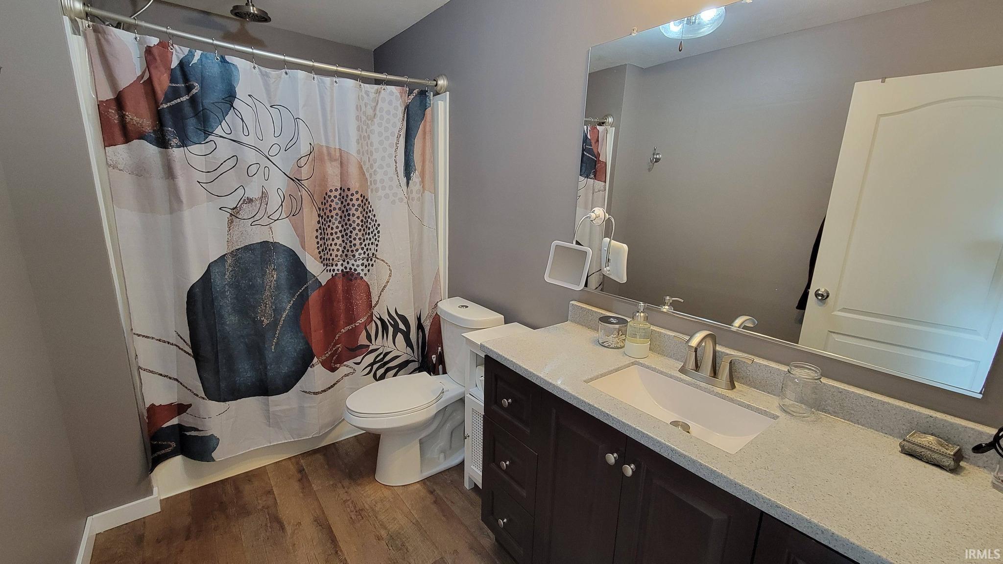 Bathroom featuring vanity and dark wood finished floors