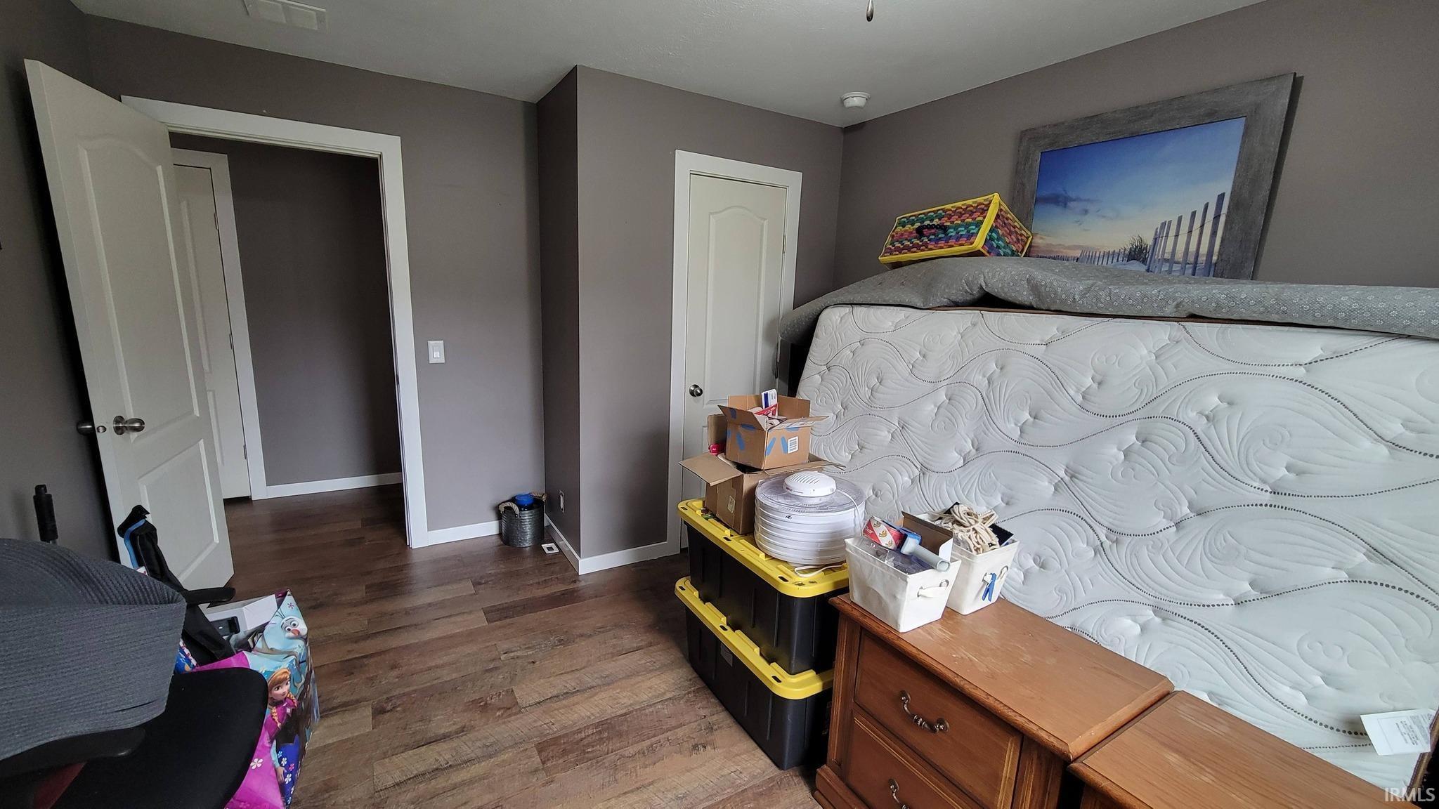 Bedroom featuring baseboards and wood finished floors