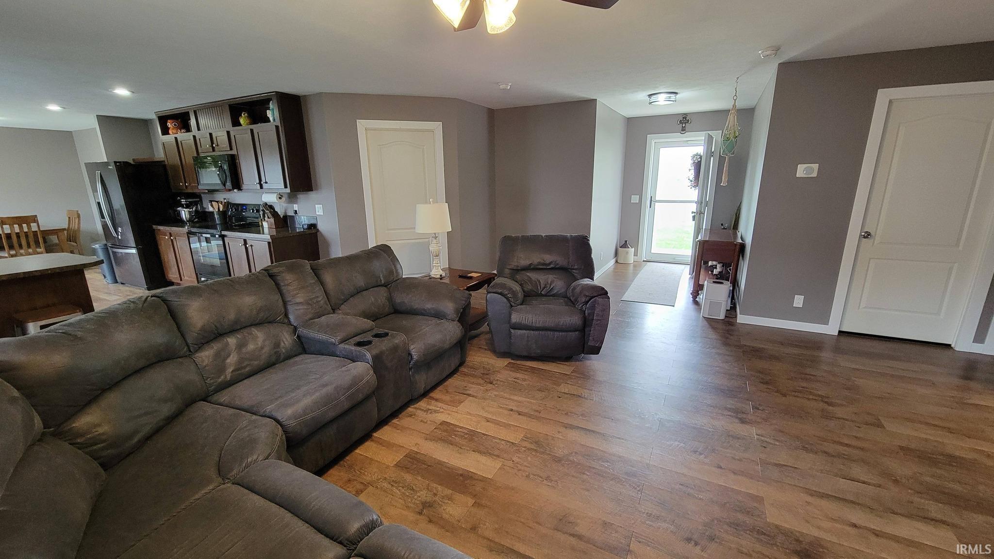 Living room featuring light wood-style flooring and a ceiling fan