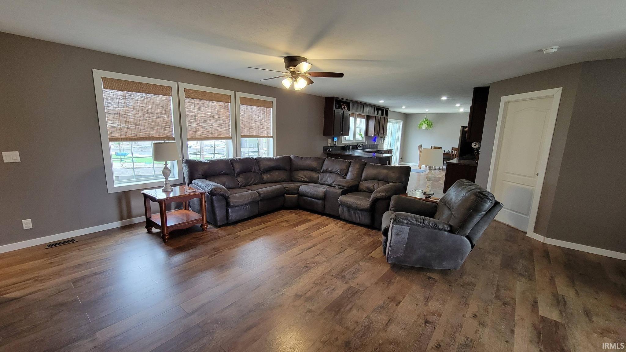 Living area featuring ceiling fan, wood finished floors, and recessed lighting