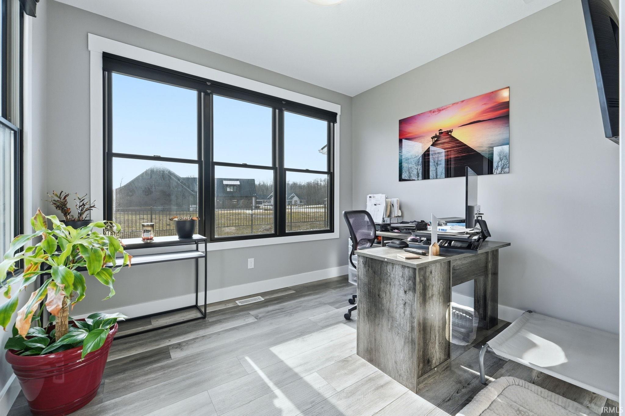 Office space featuring baseboards and light wood-style flooring