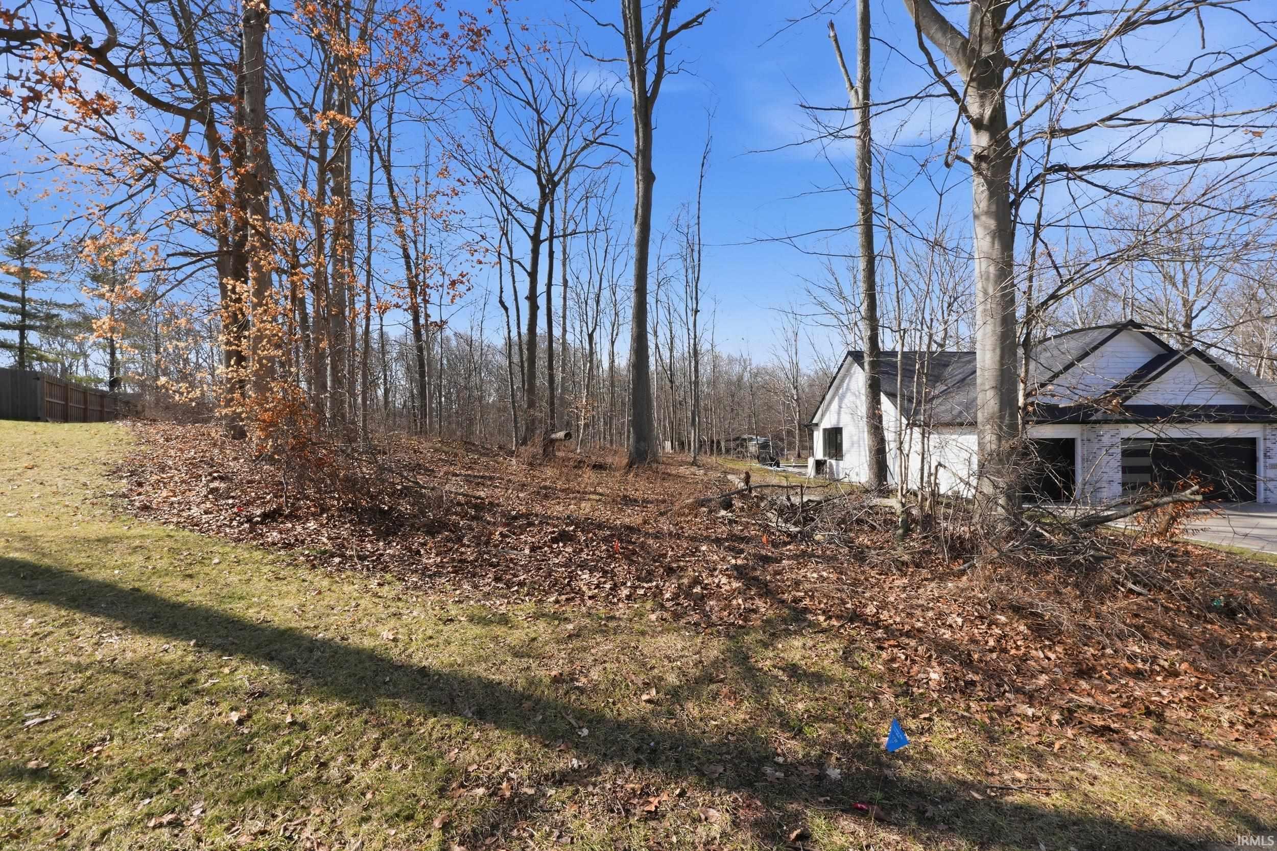 View of grassy yard featuring a garage