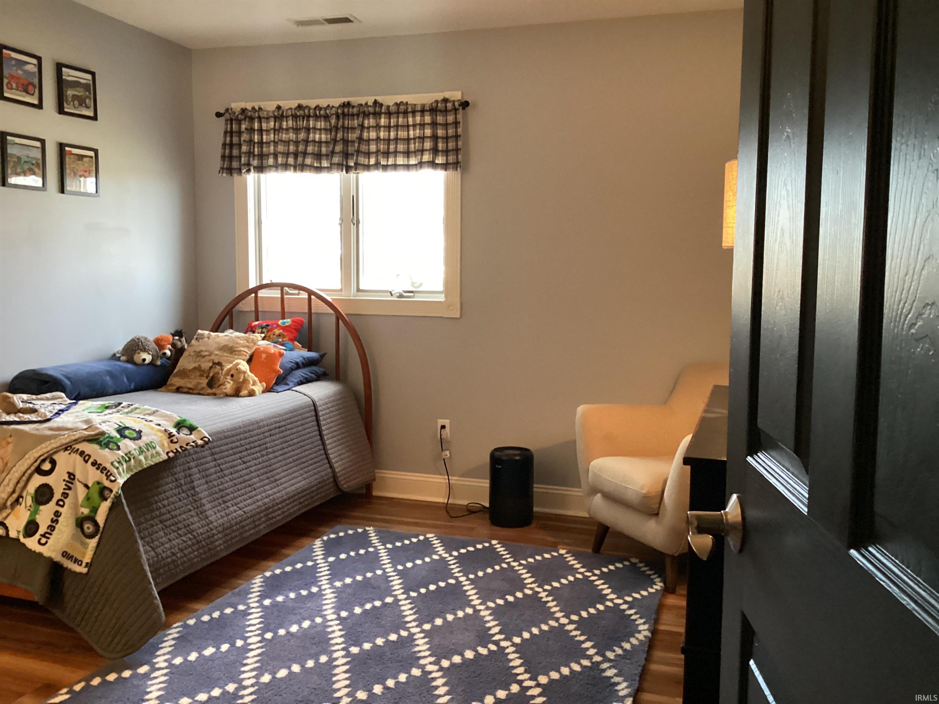 Bedroom featuring dark wood-style floors