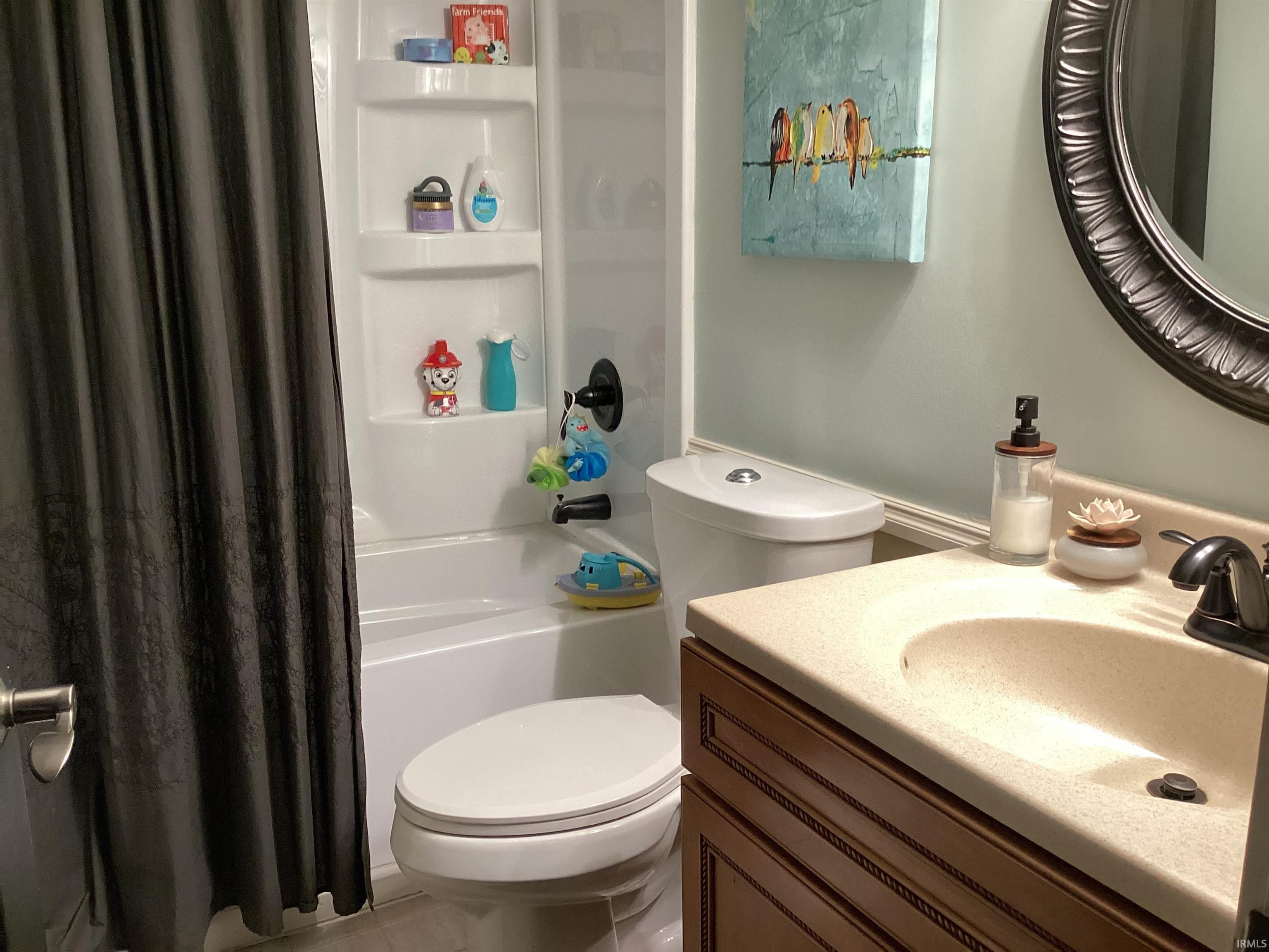 Full bath with vanity and shower / bath combo with shower curtain