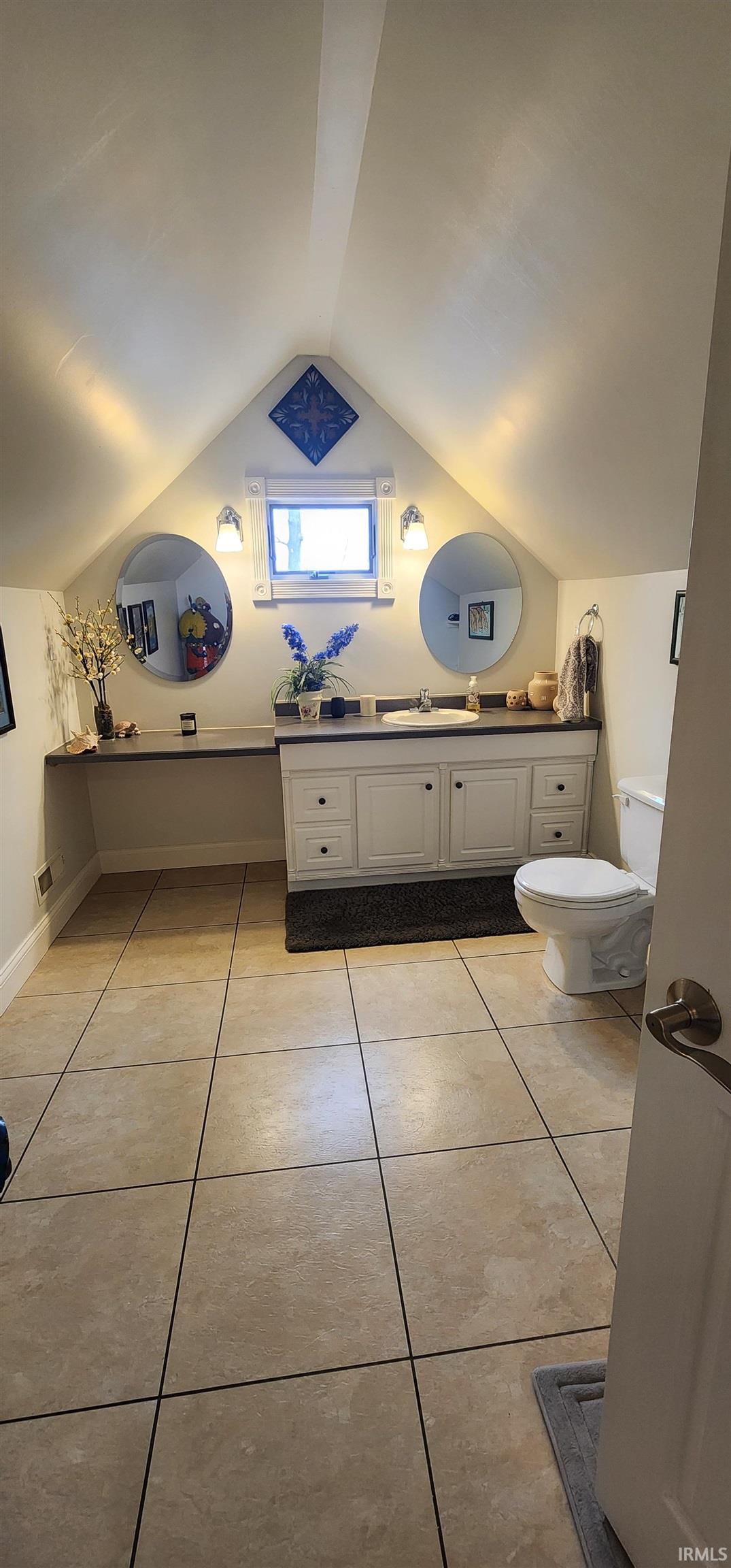 Bathroom featuring vanity and light tile patterned floors
