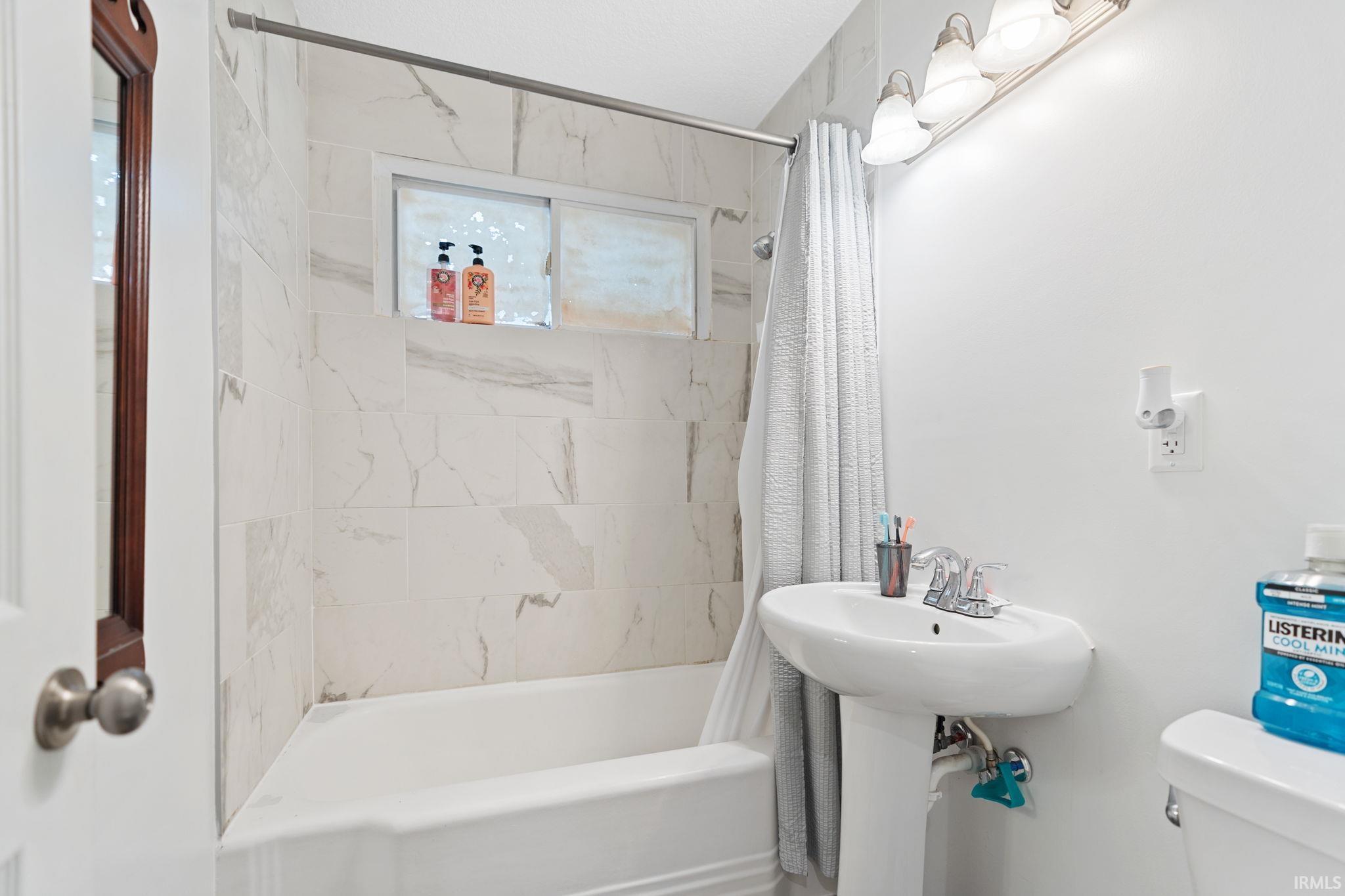 Bathroom with toilet and shower / tub combo
