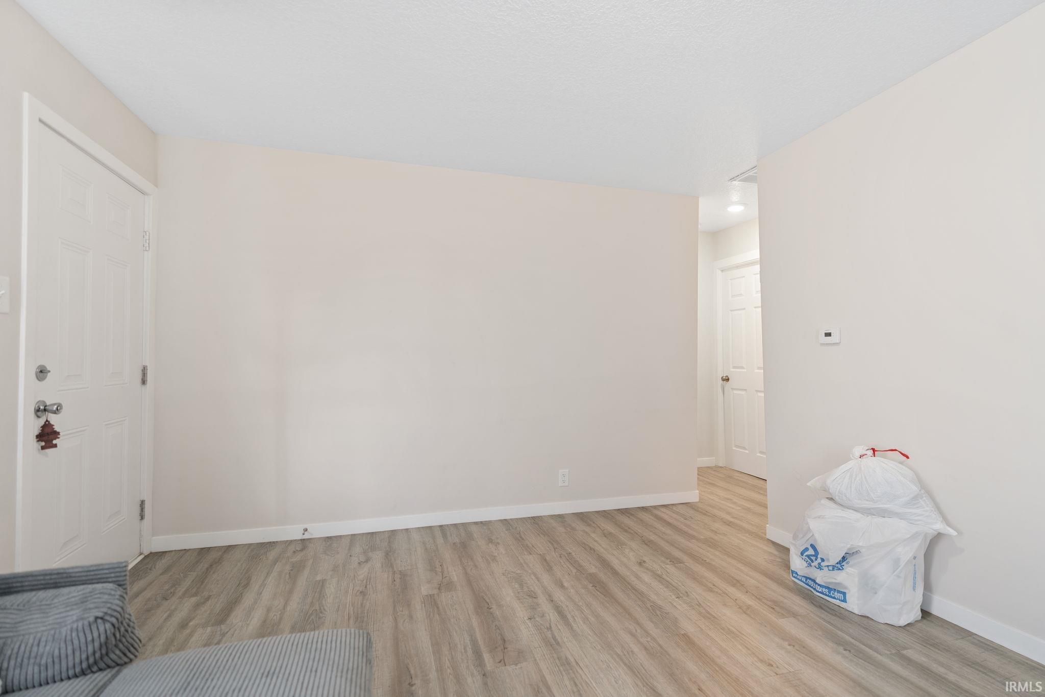 Interior space with light wood-style flooring and baseboards
