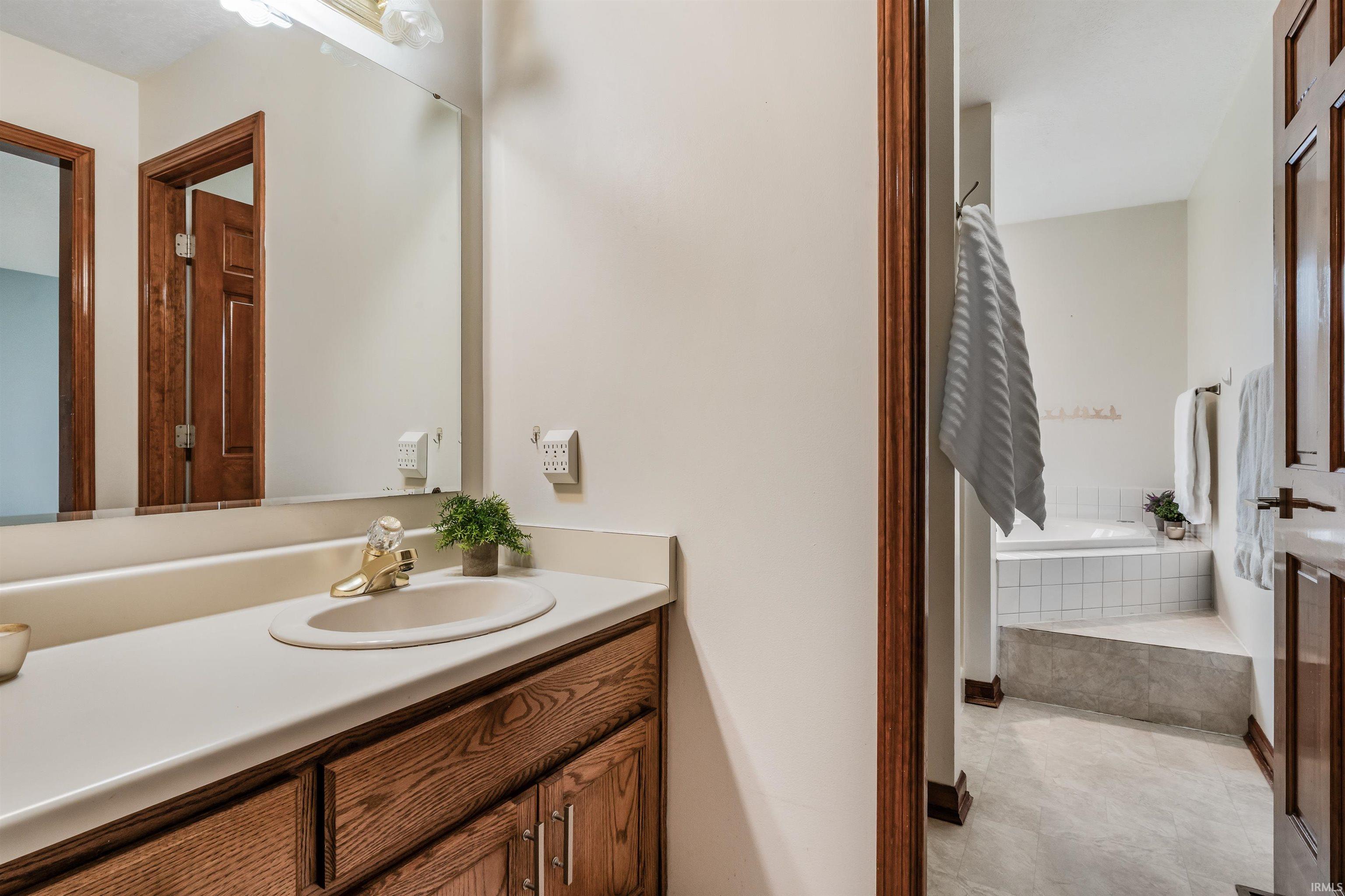 Bathroom featuring vanity and a garden tub
