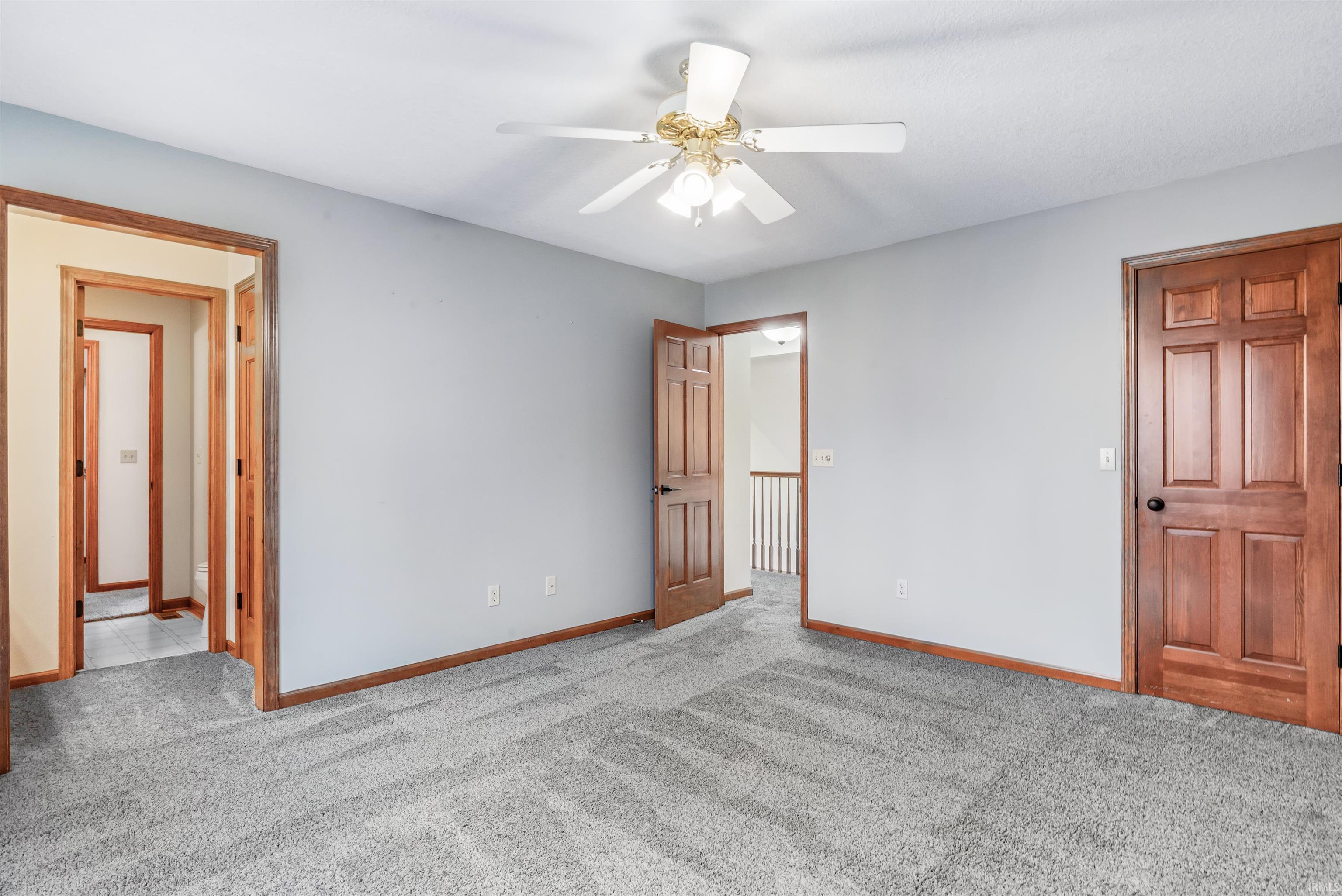Unfurnished bedroom featuring light colored carpet and a ceiling fan