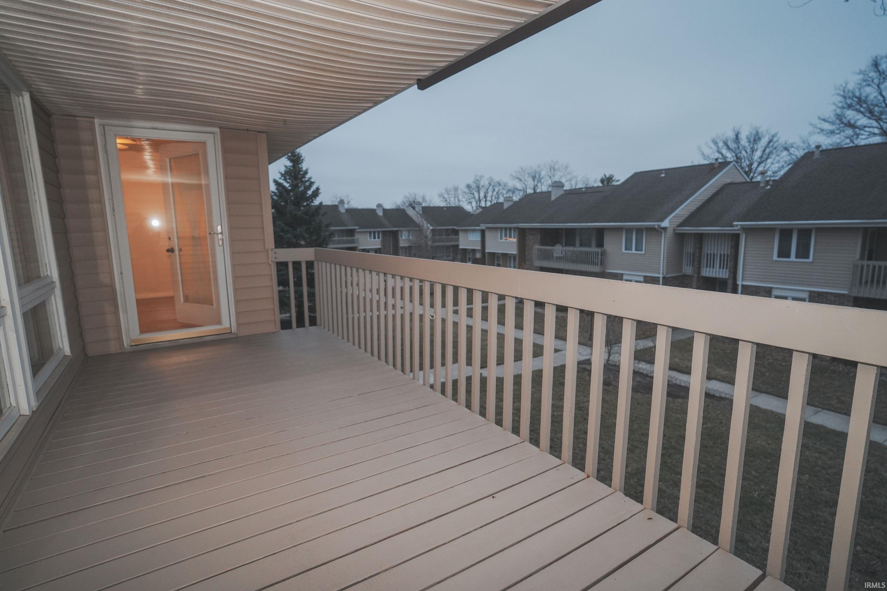 Wooden deck with a residential view