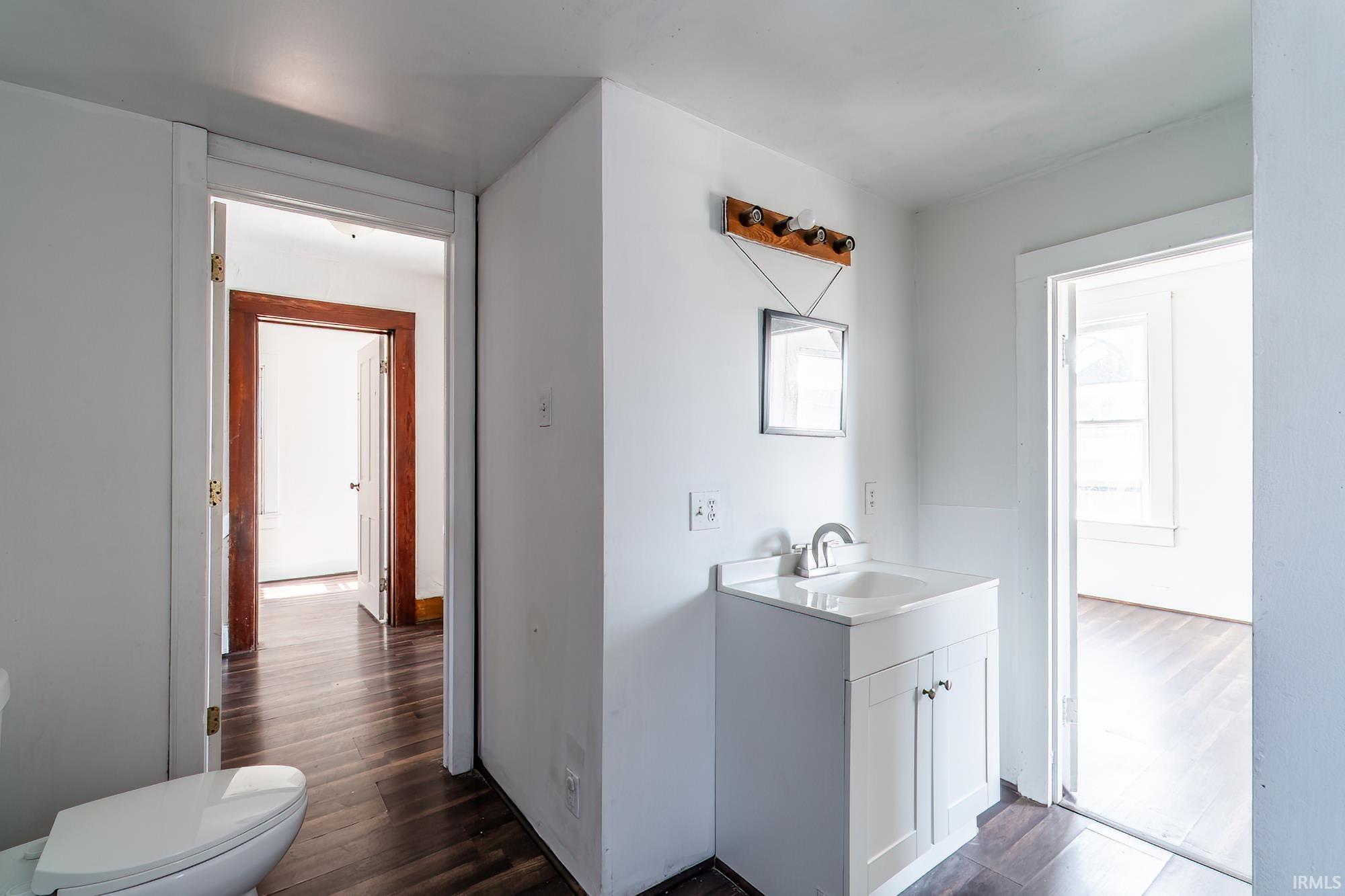 Bathroom with vanity and dark wood-type flooring