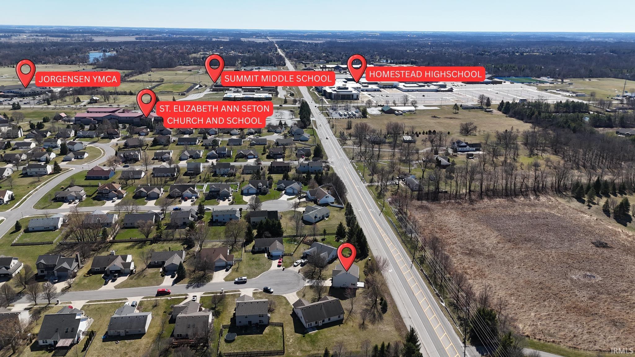 Aerial overview of property's location with nearby suburban area