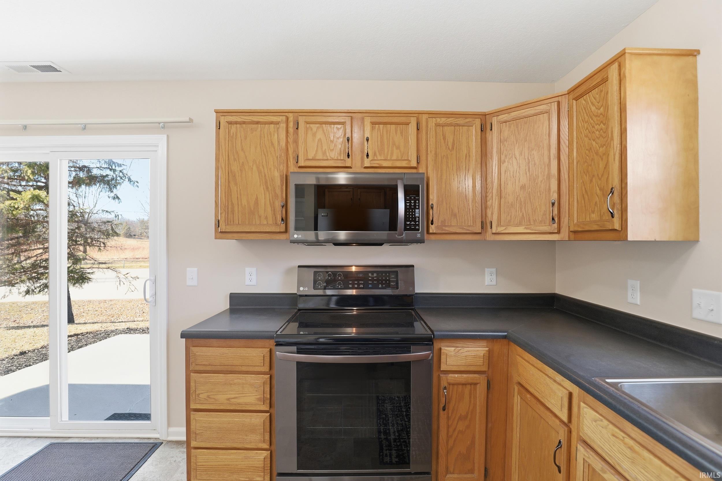 Kitchen with stainless steel appliances and dark countertops