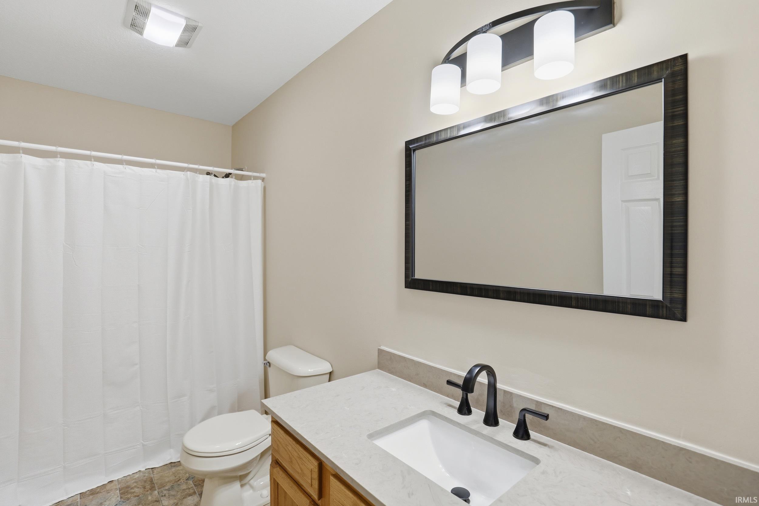 Bathroom featuring vanity and a shower with shower curtain