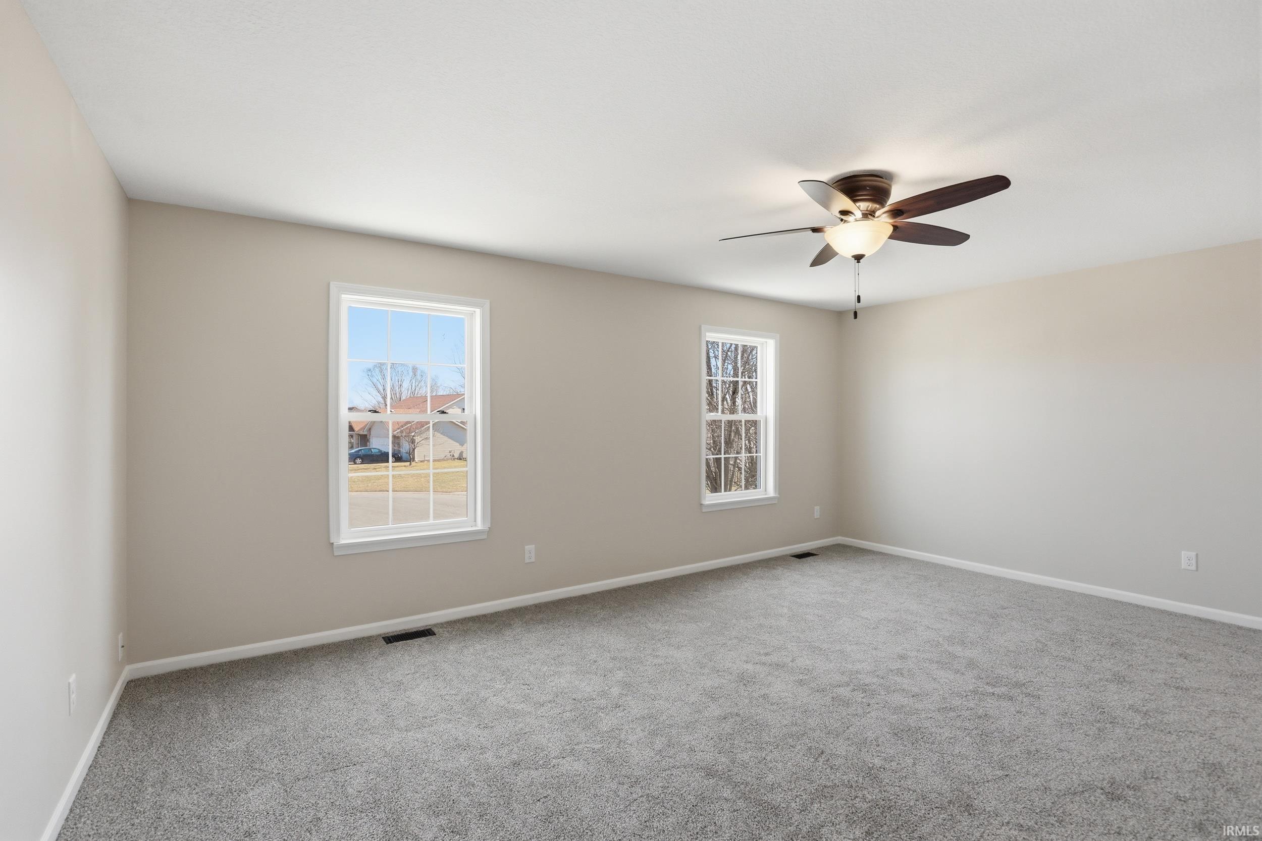 Empty room featuring carpet and a ceiling fan