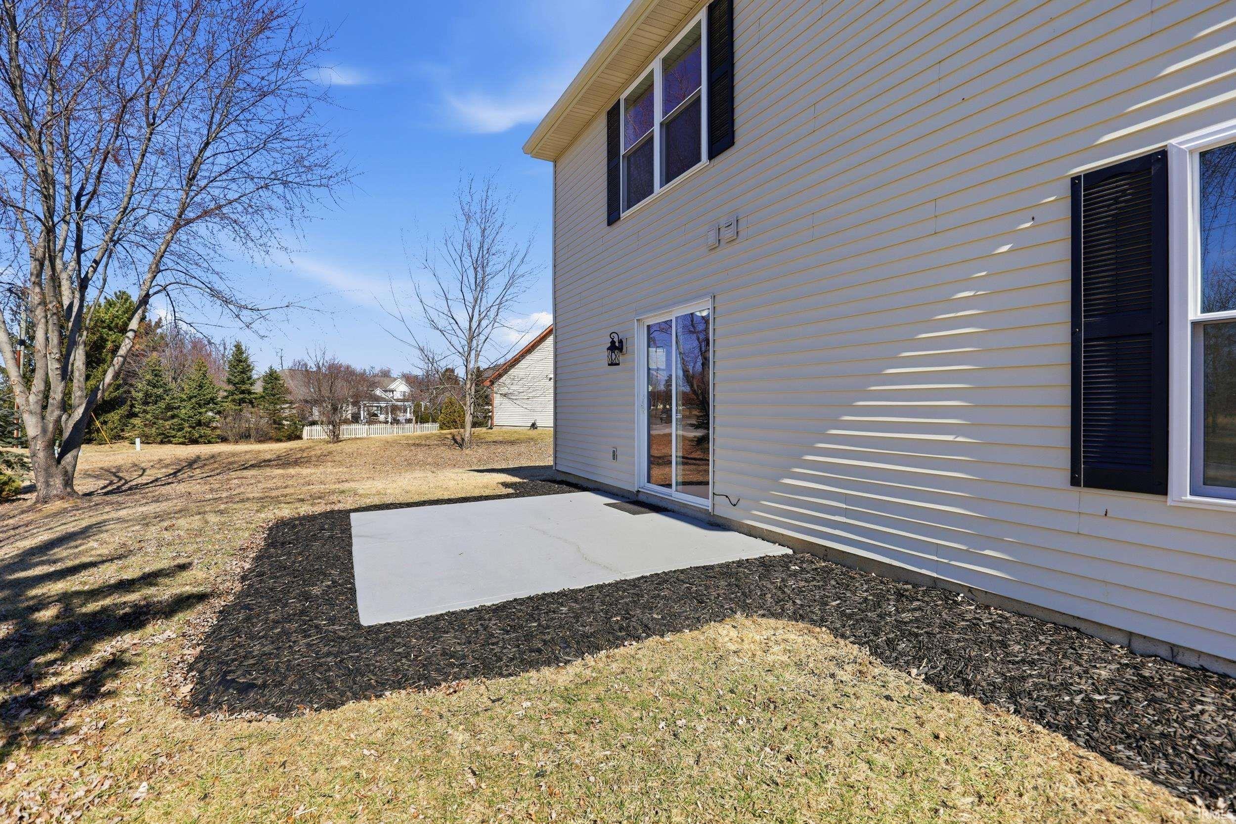 Rear view of house featuring a patio area and a lawn