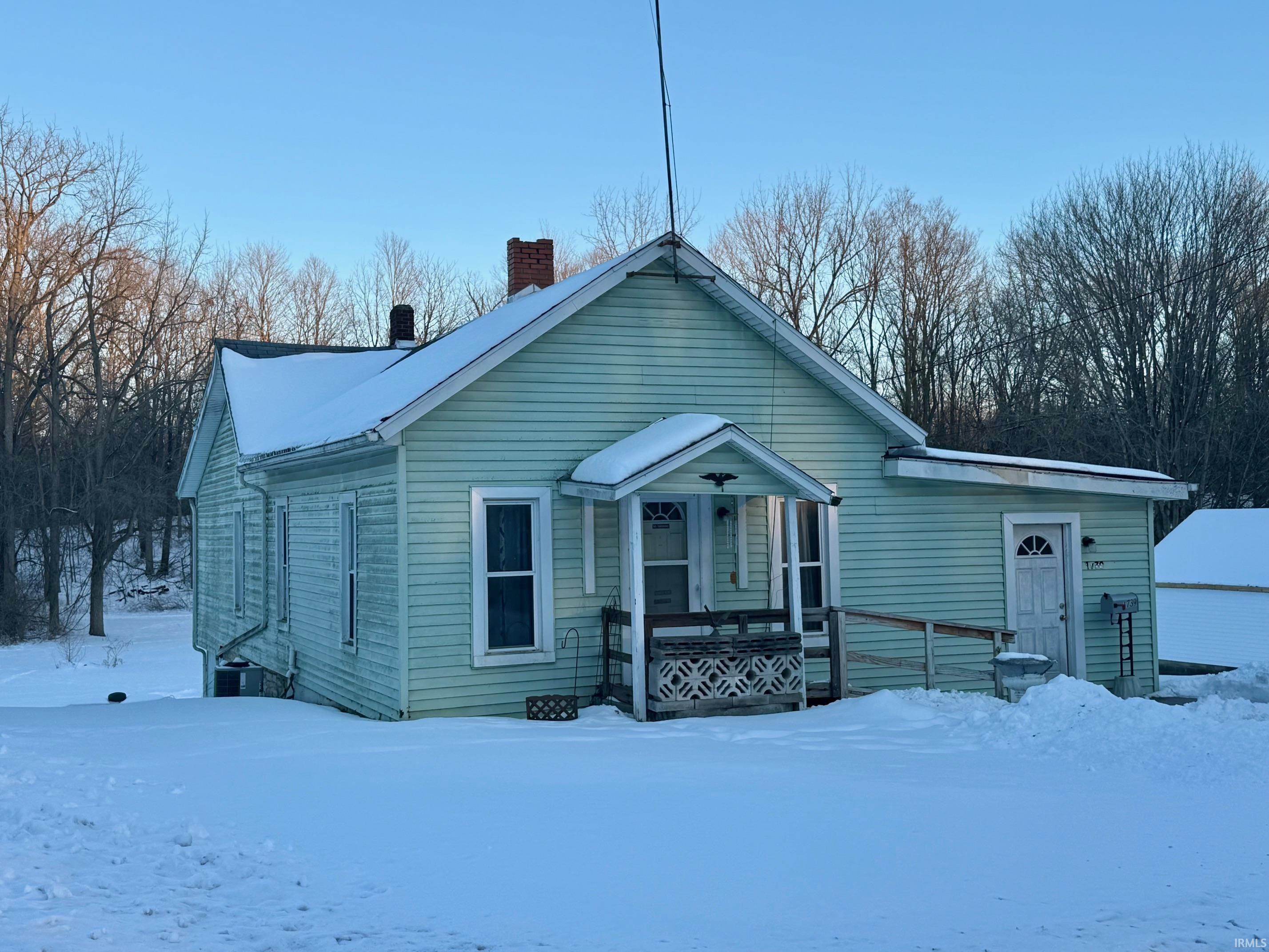 View of front of home featuring a chimney