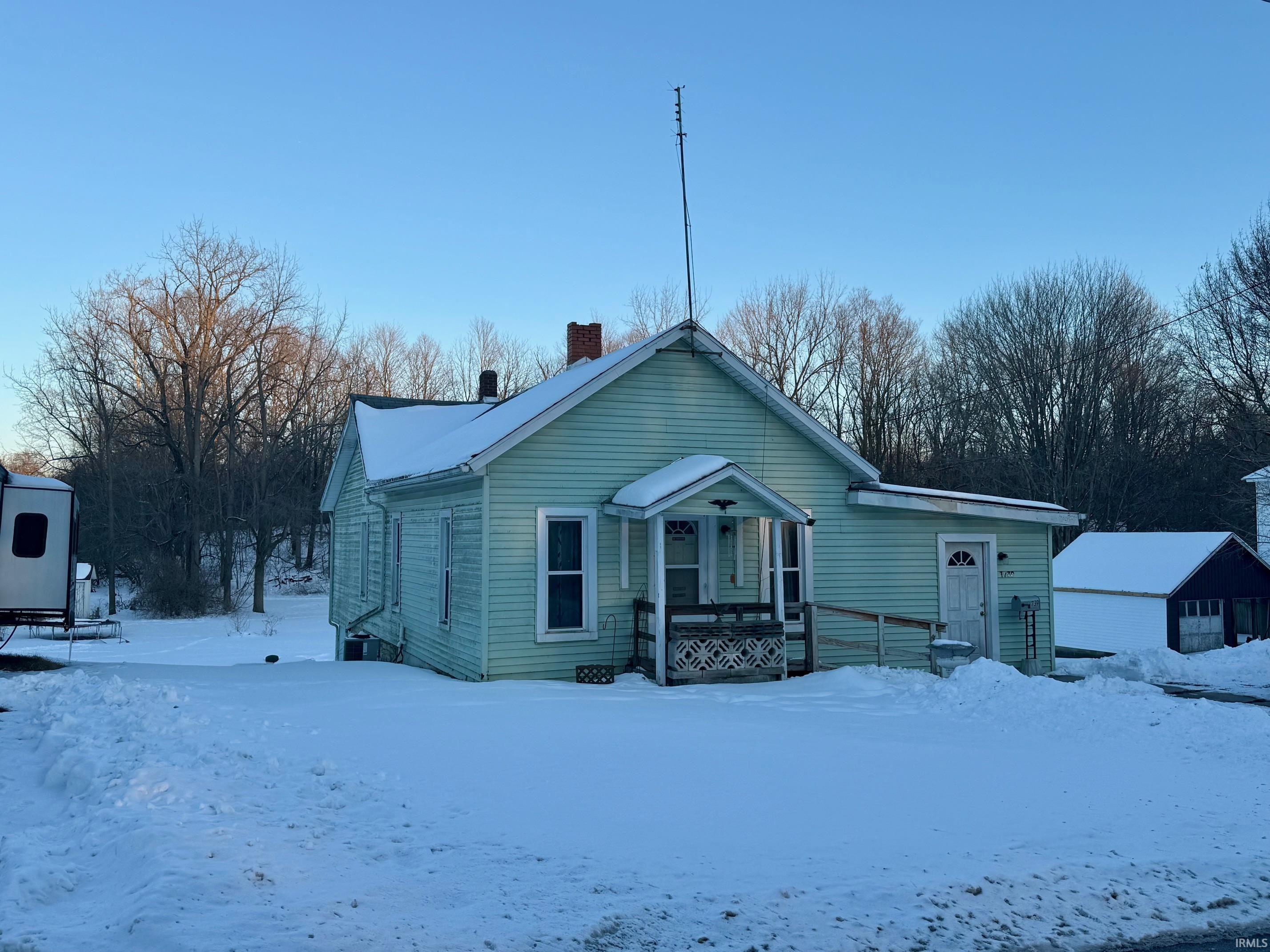 View of front of home featuring a chimney