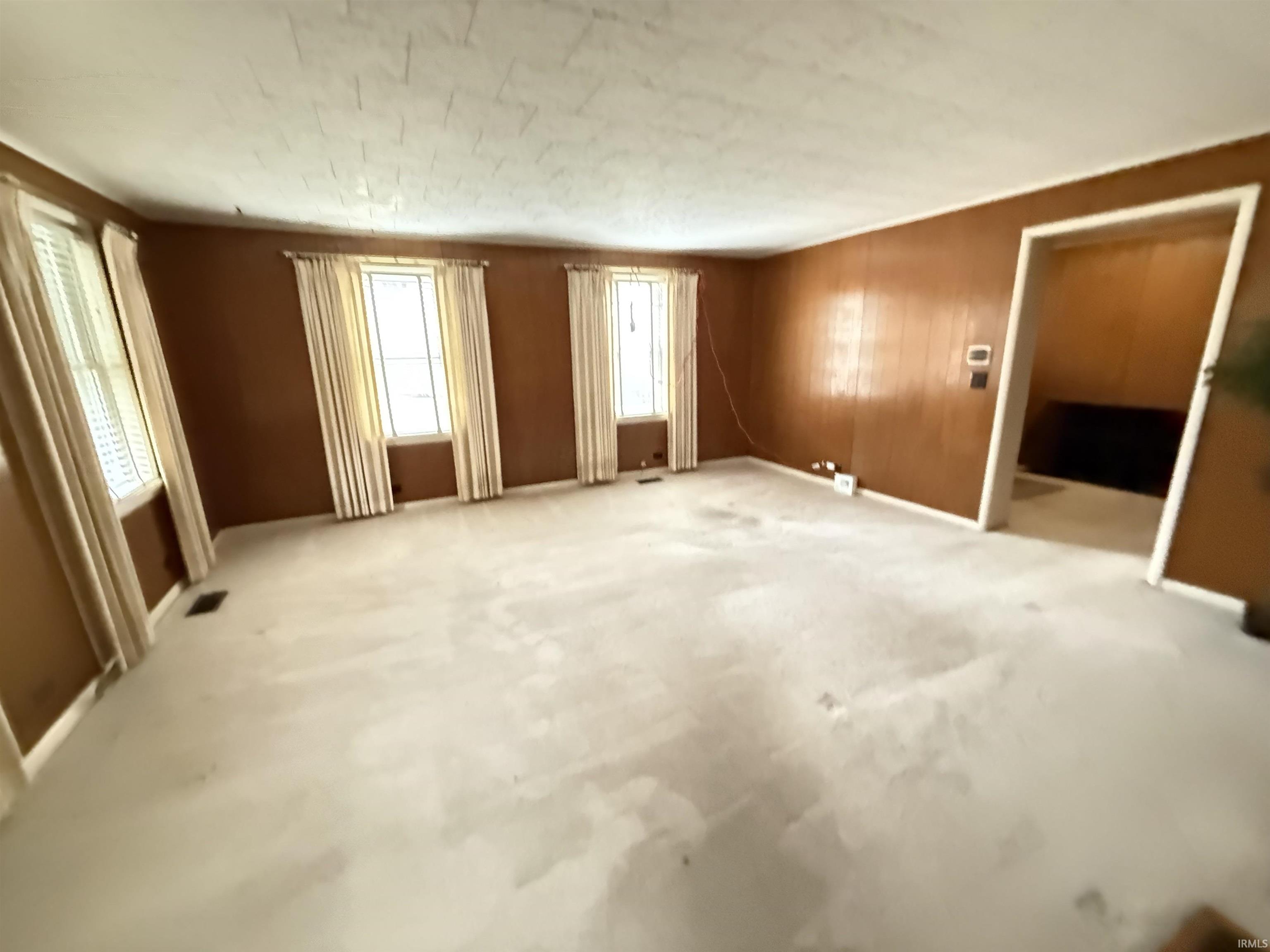 Empty room with carpet floors and baseboards