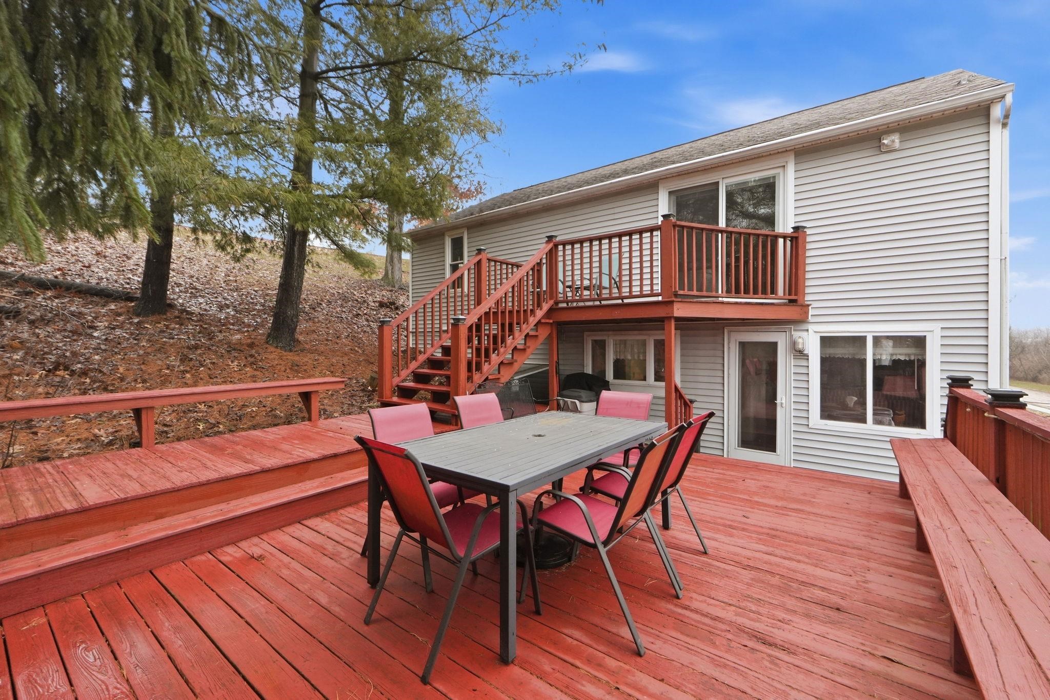 Wooden deck featuring stairway and outdoor dining space