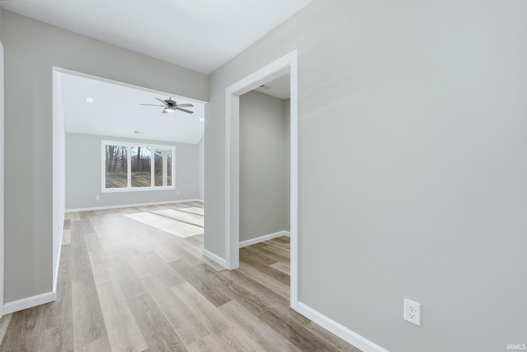 Corridor with light wood finished floors and baseboards