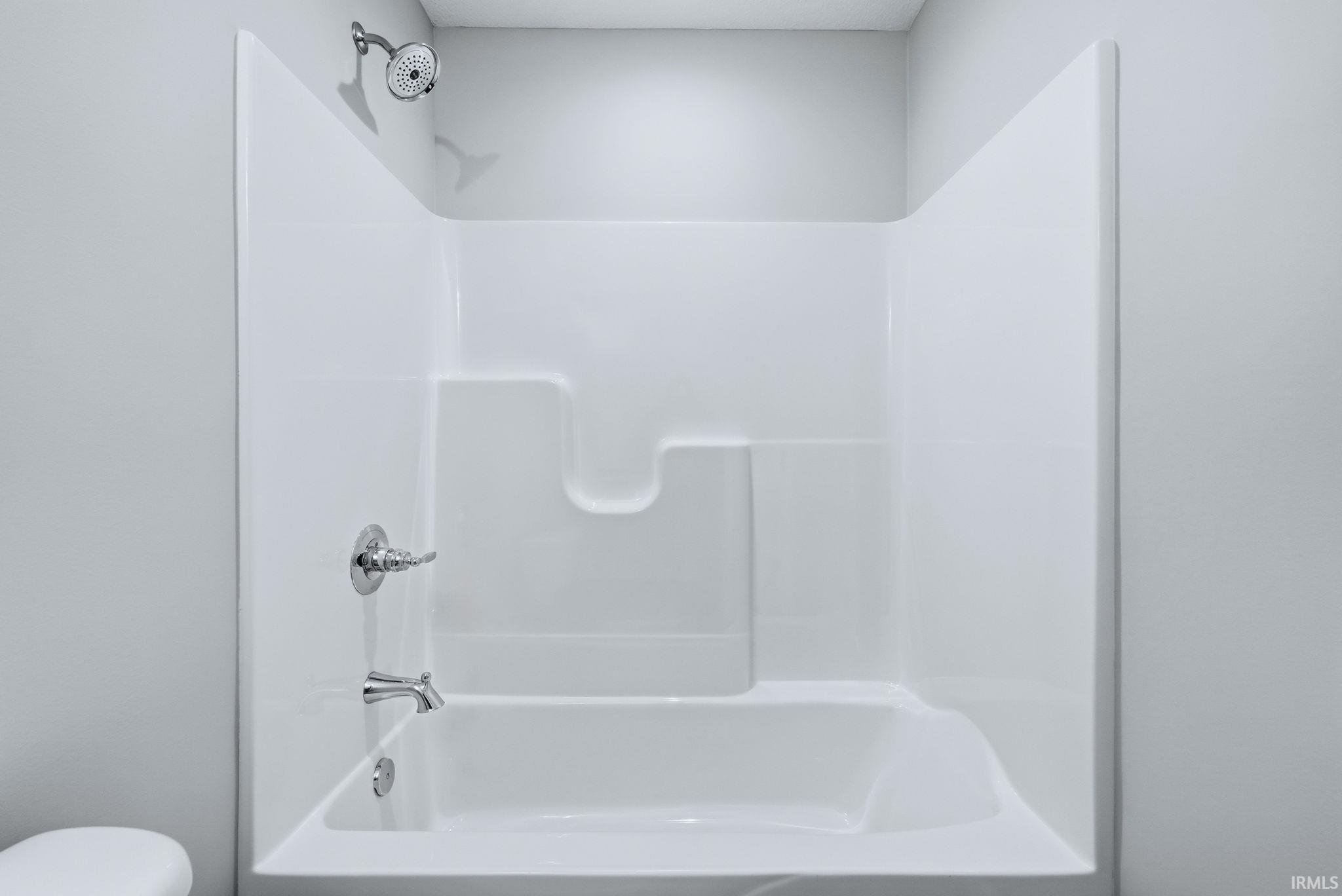 Bathroom with shower / bathtub combination and toilet