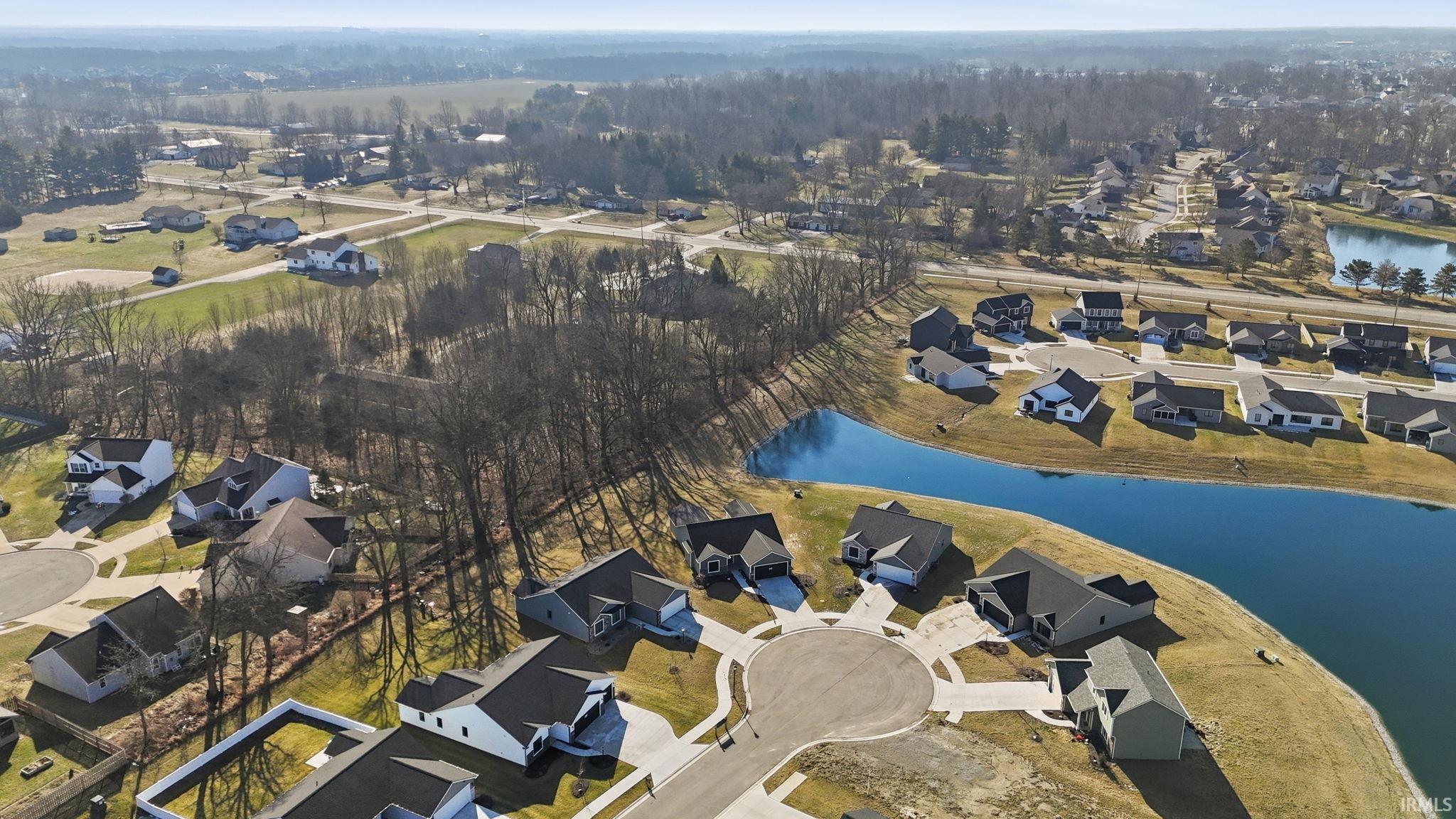 Aerial view of property's location with nearby suburban area and a large body of water