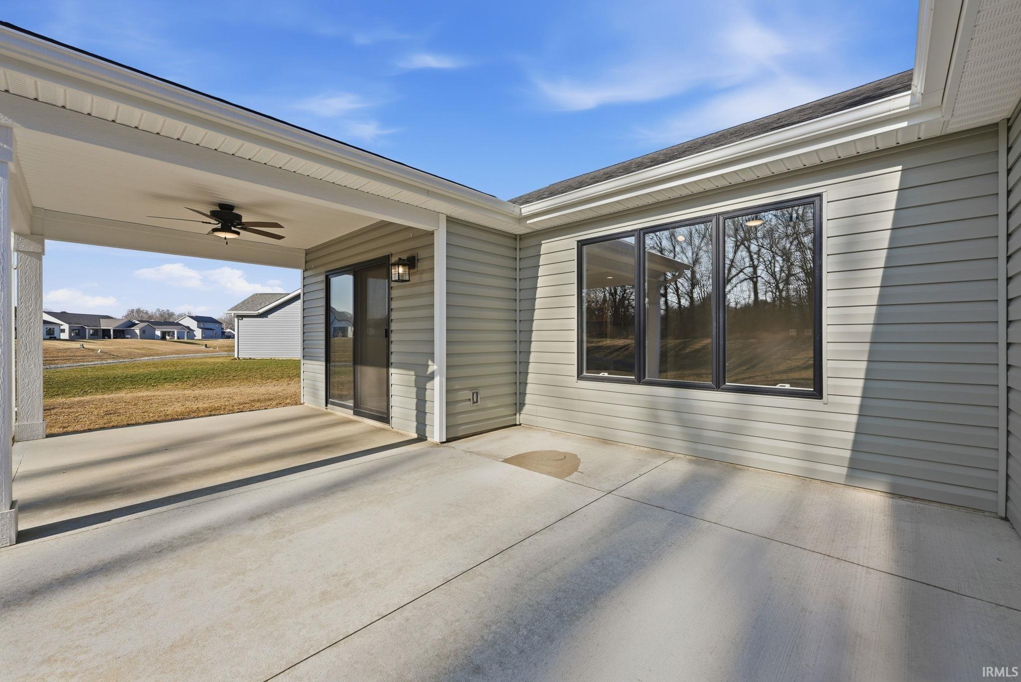 View of patio featuring a ceiling fan and a residential view