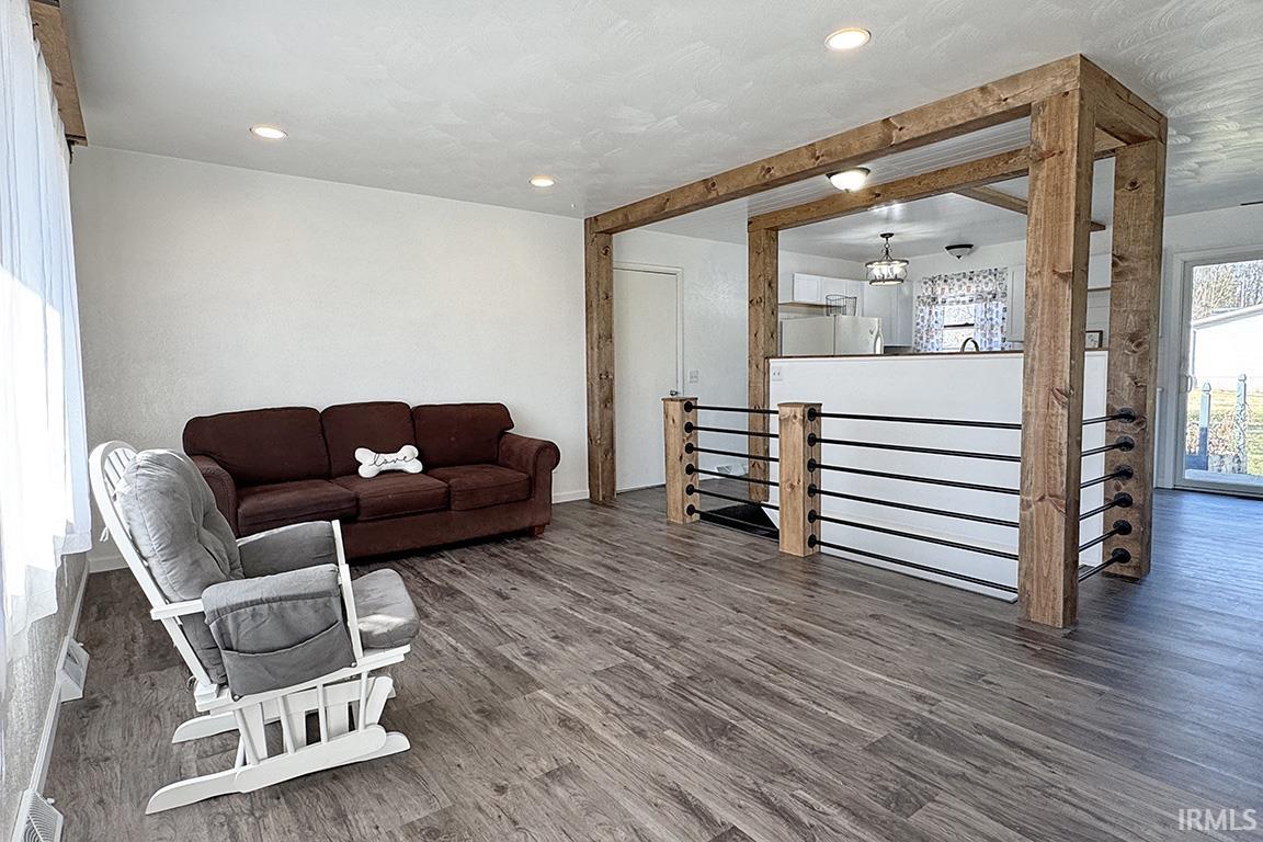 Living area featuring dark wood-style floors and recessed lighting