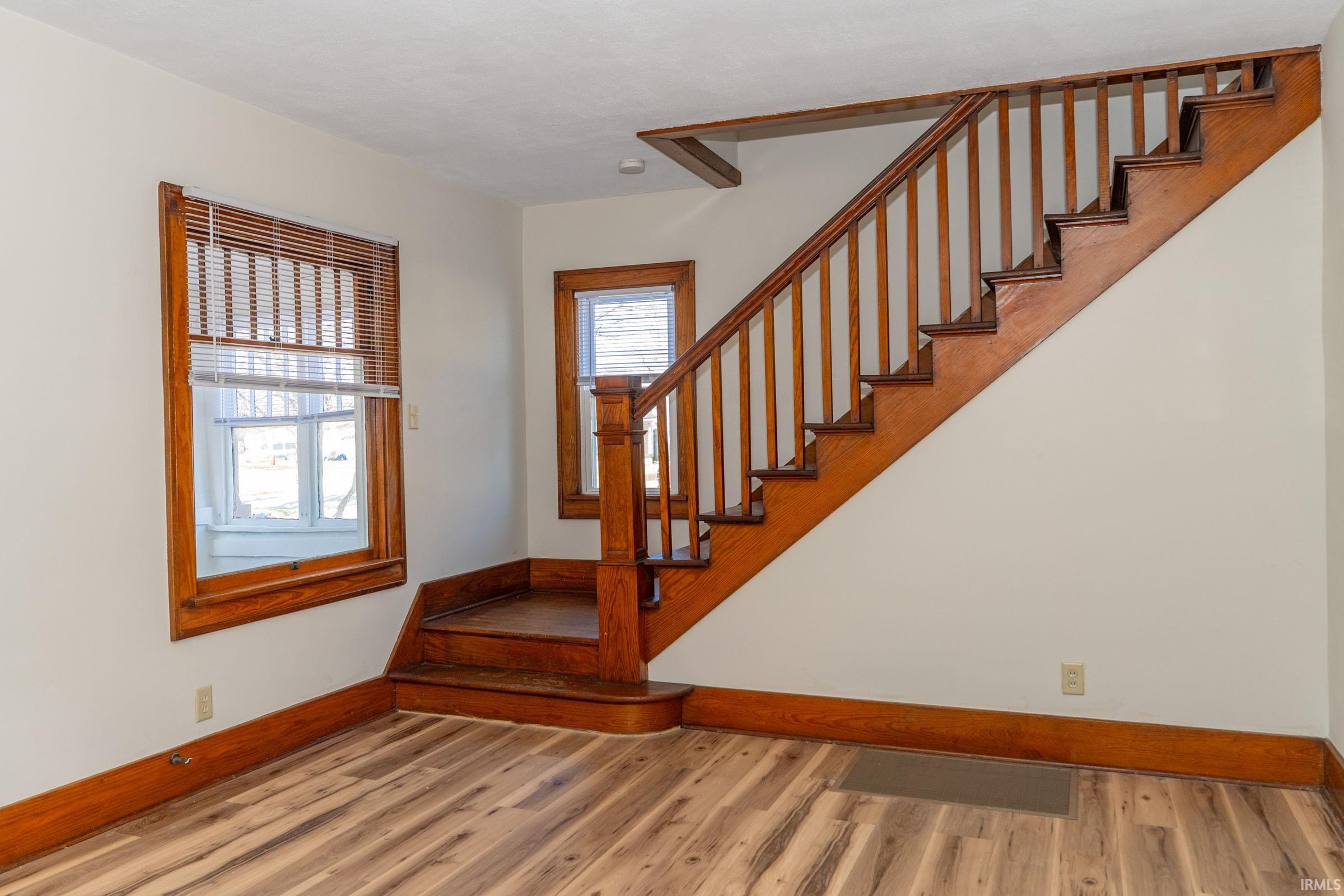 Entrance foyer with stairs and light wood-style flooring