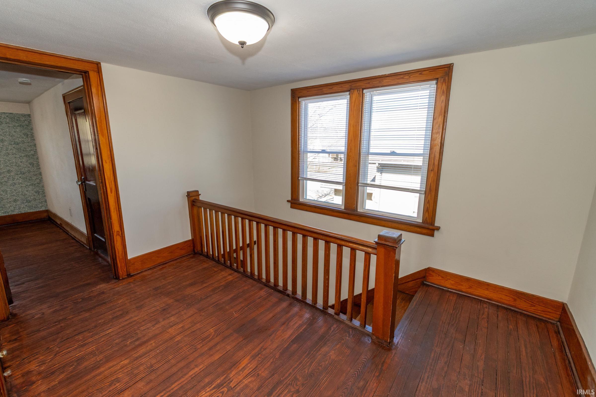Stairway featuring wood-type flooring and baseboards