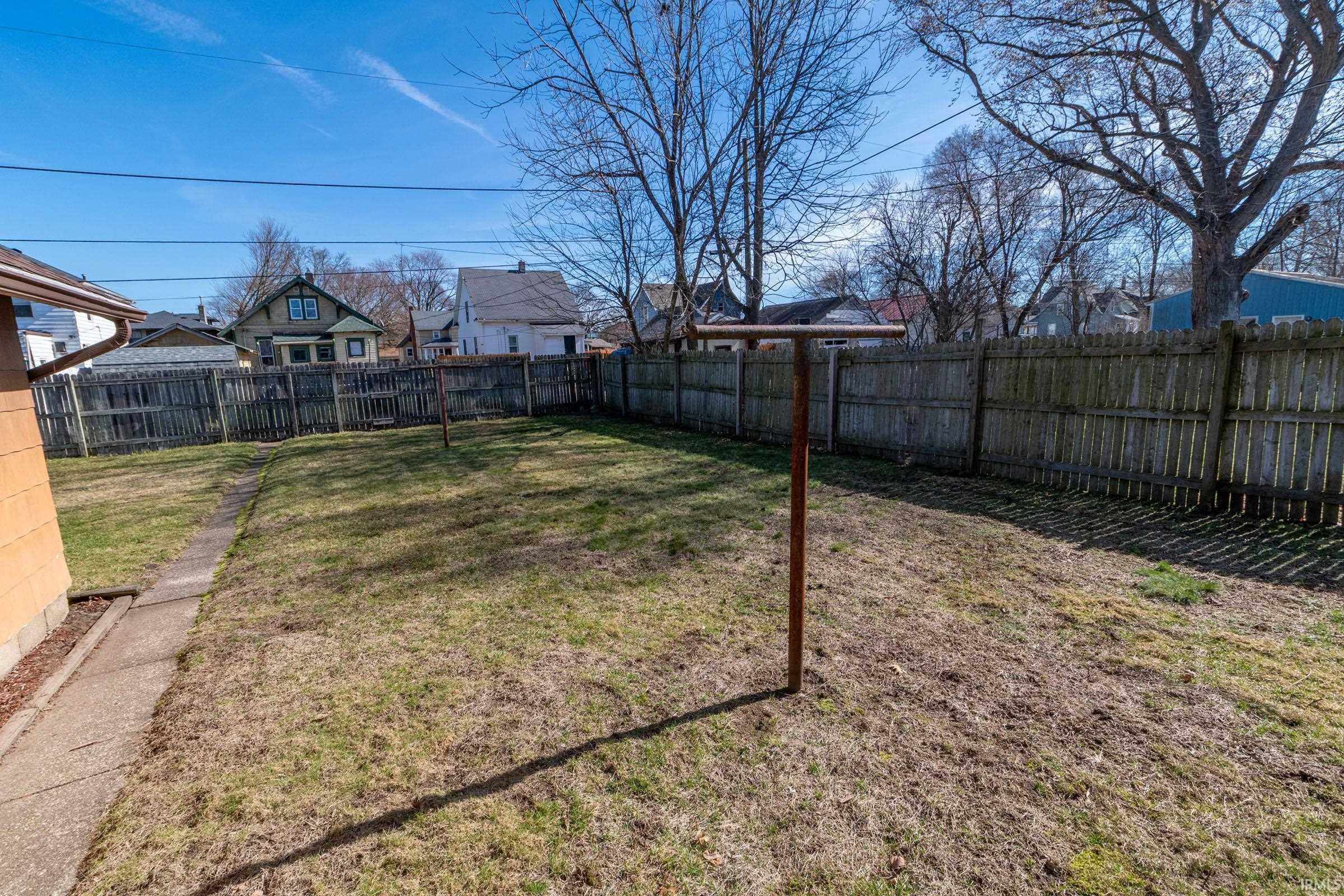 Fenced backyard with a residential view