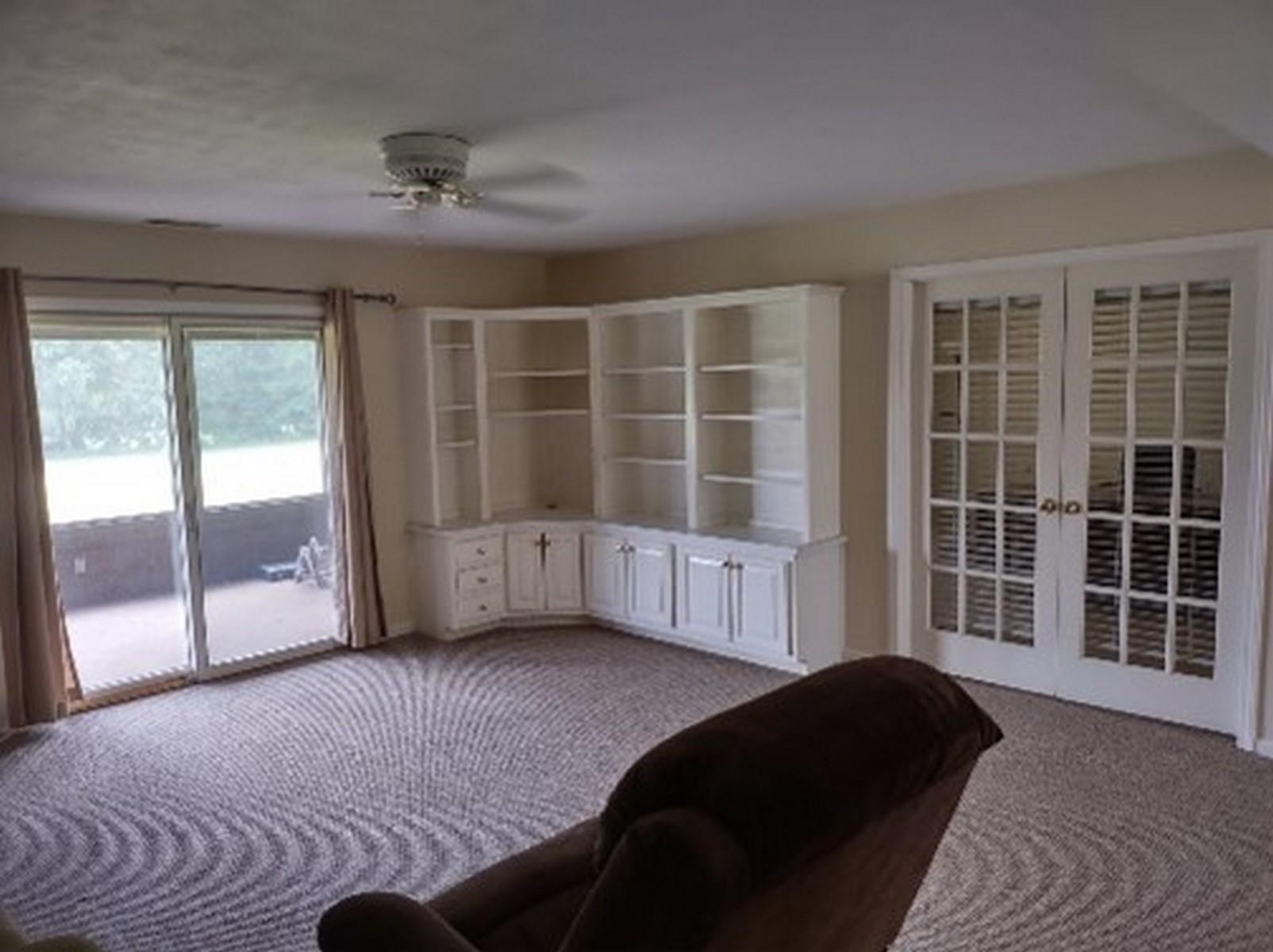 Unfurnished room with french doors, carpet flooring, and ceiling fan
