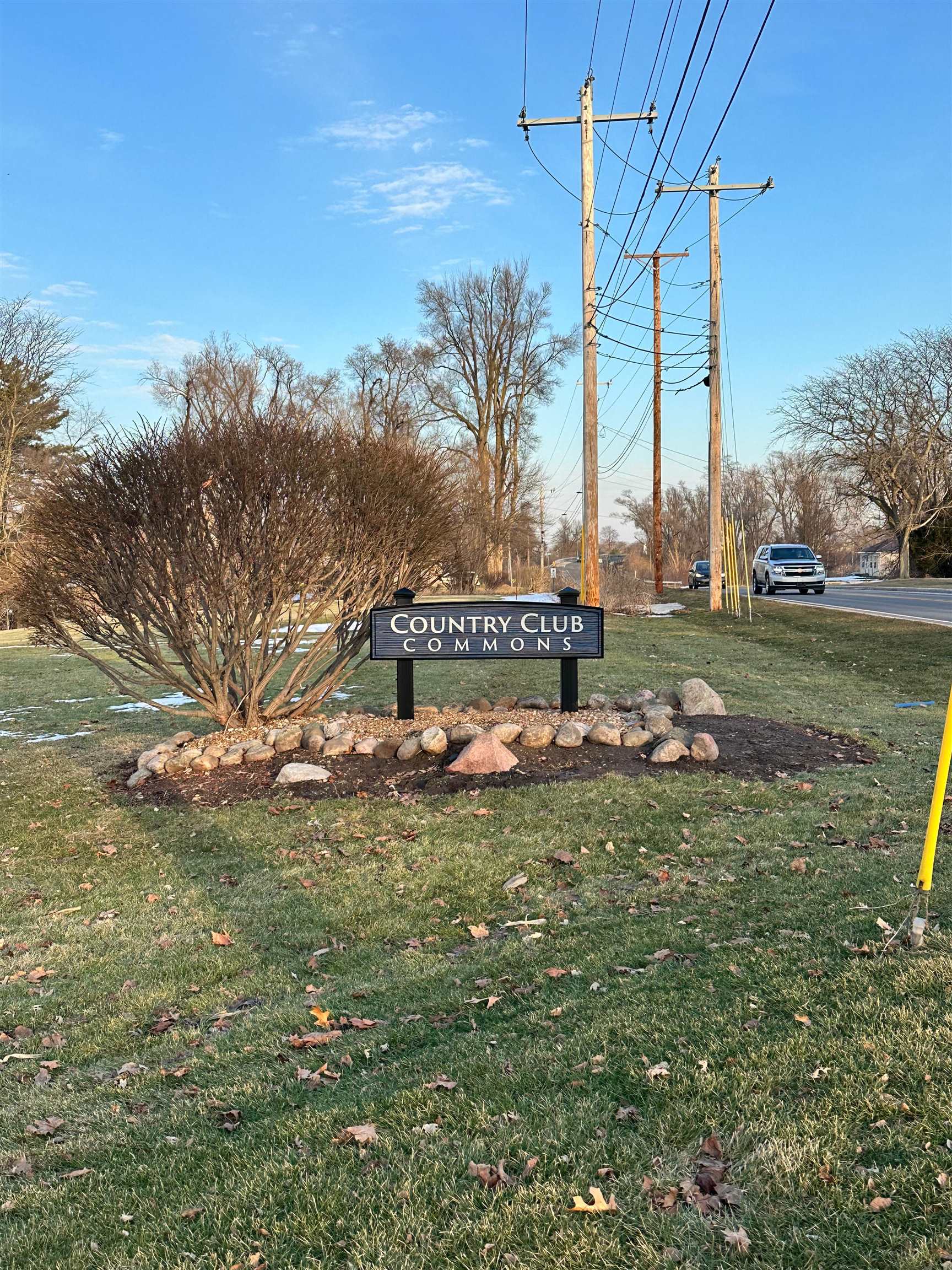 Community / neighborhood sign with a lawn