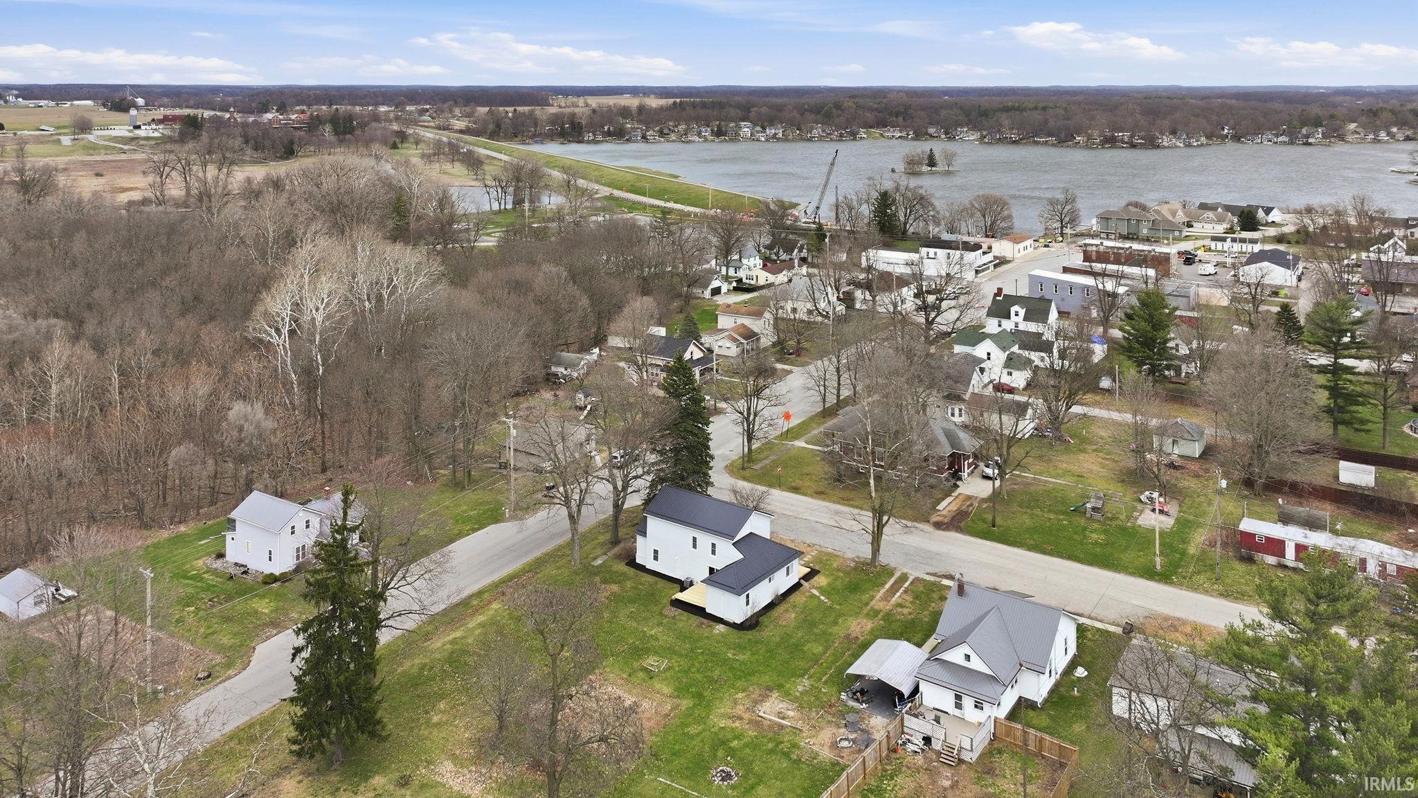 Aerial view of residential area featuring a nearby body of water