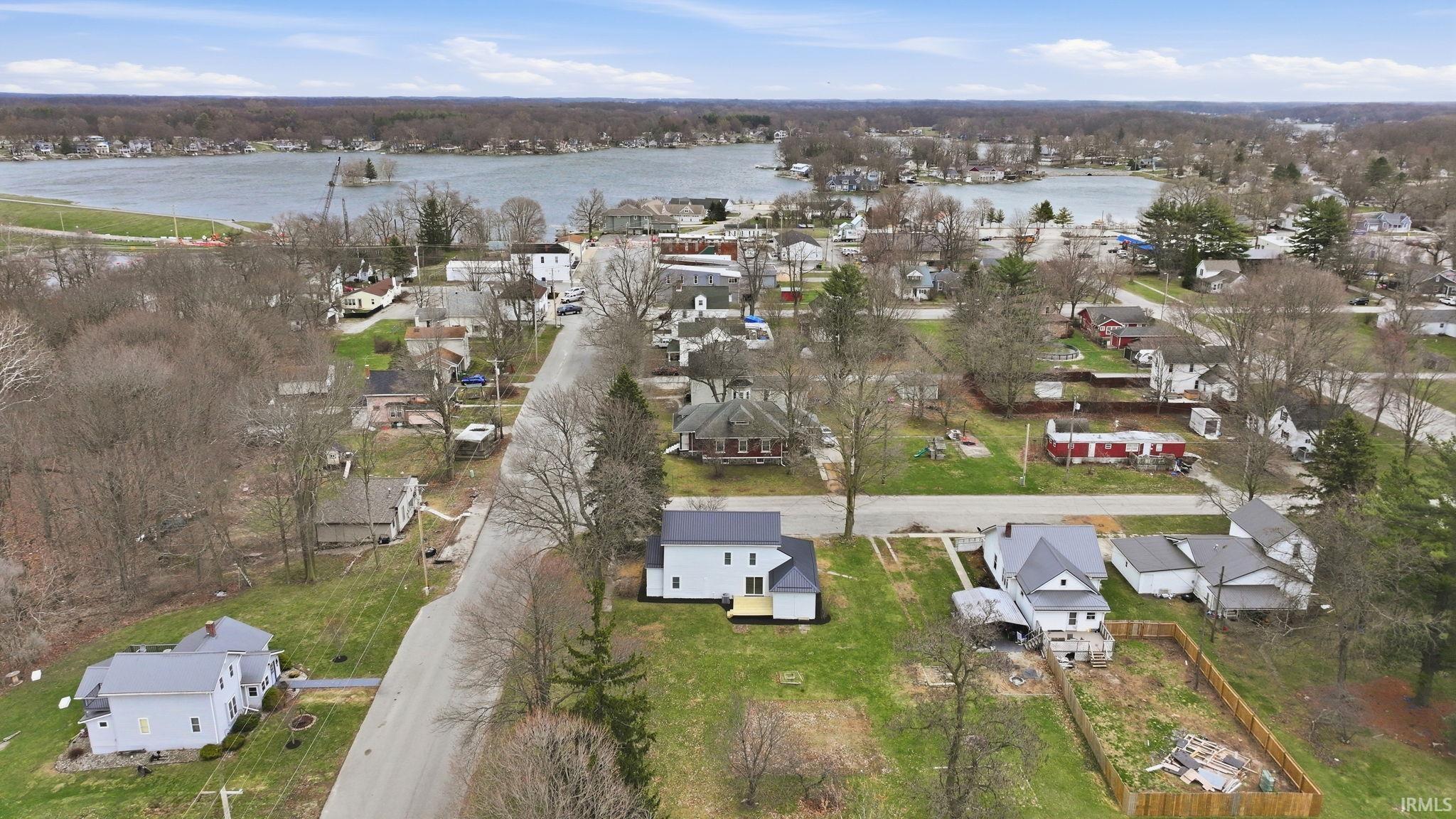 Aerial perspective of suburban area with a large body of water