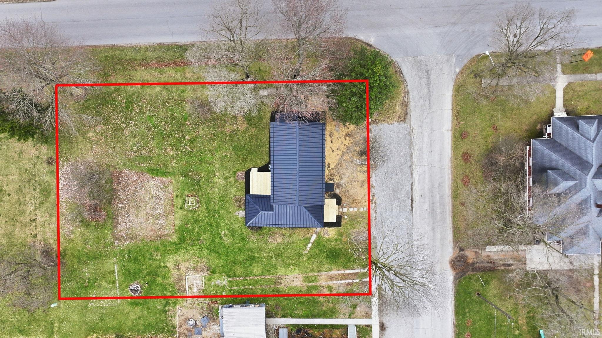 Aerial view of property and surrounding area featuring property boundaries highlighted