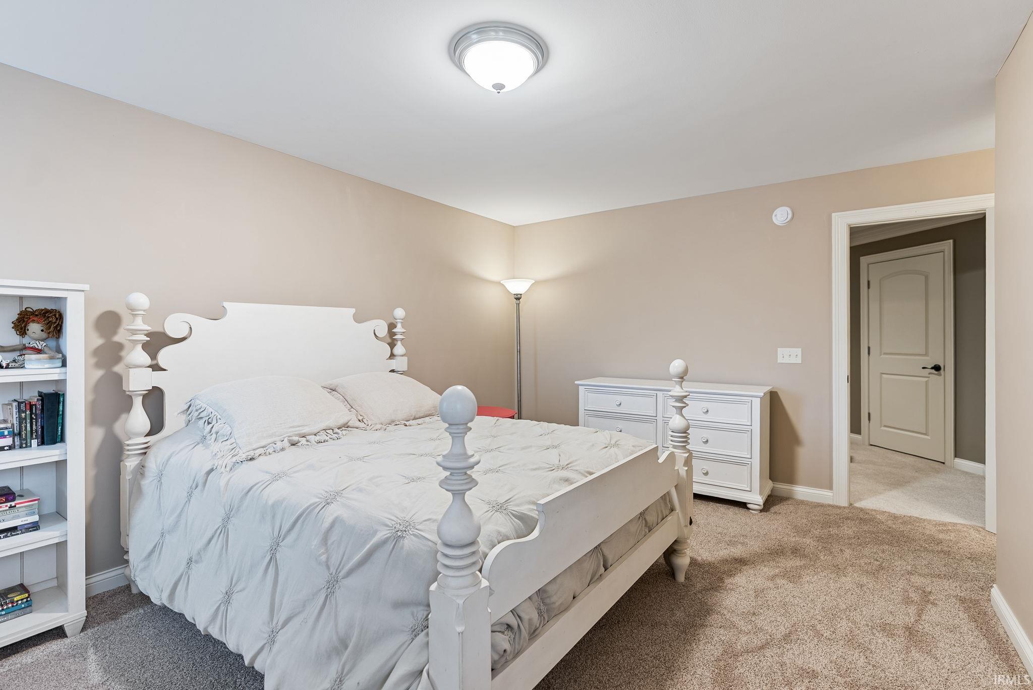 Bedroom featuring light colored carpet