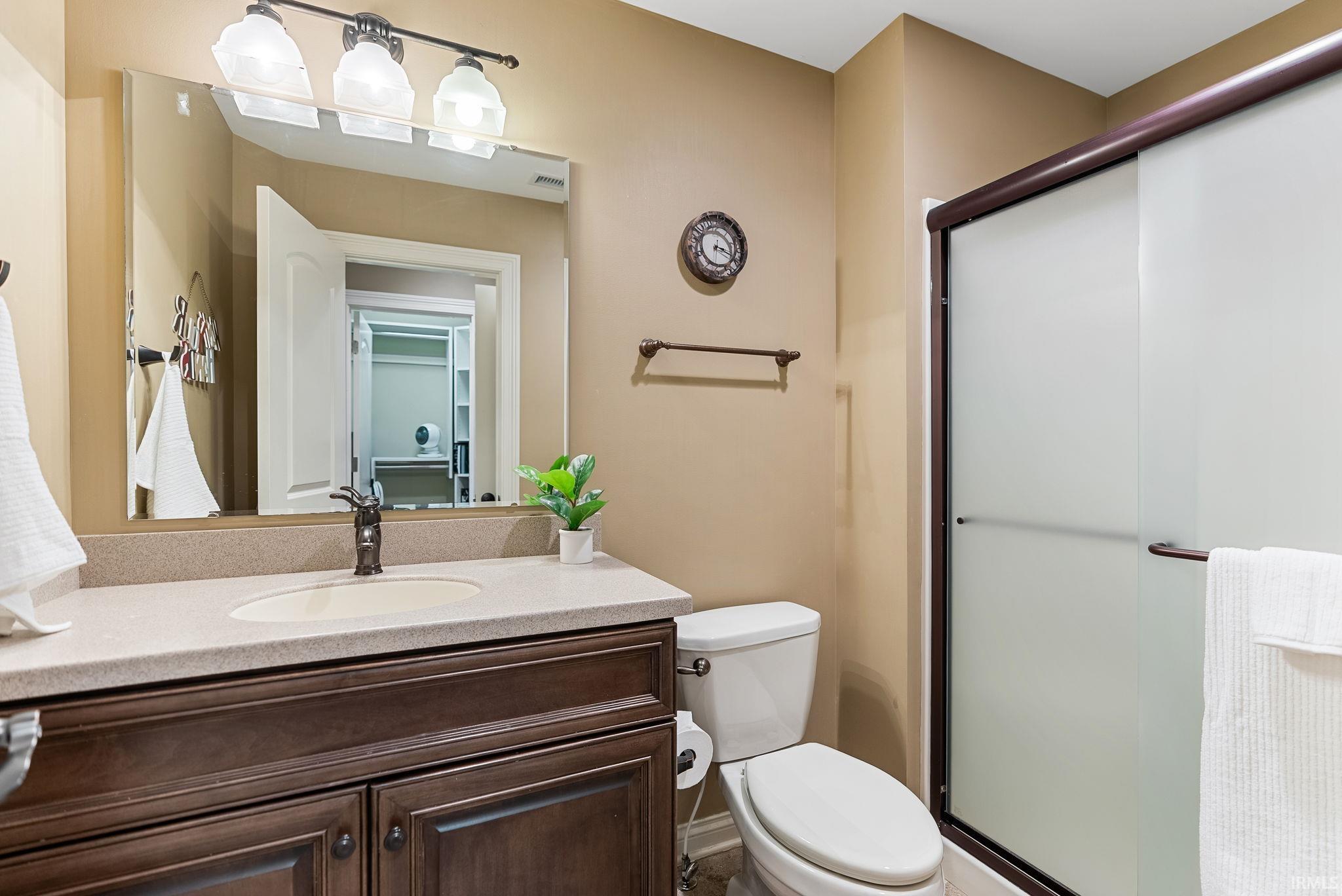 Full bath with vanity and a shower stall