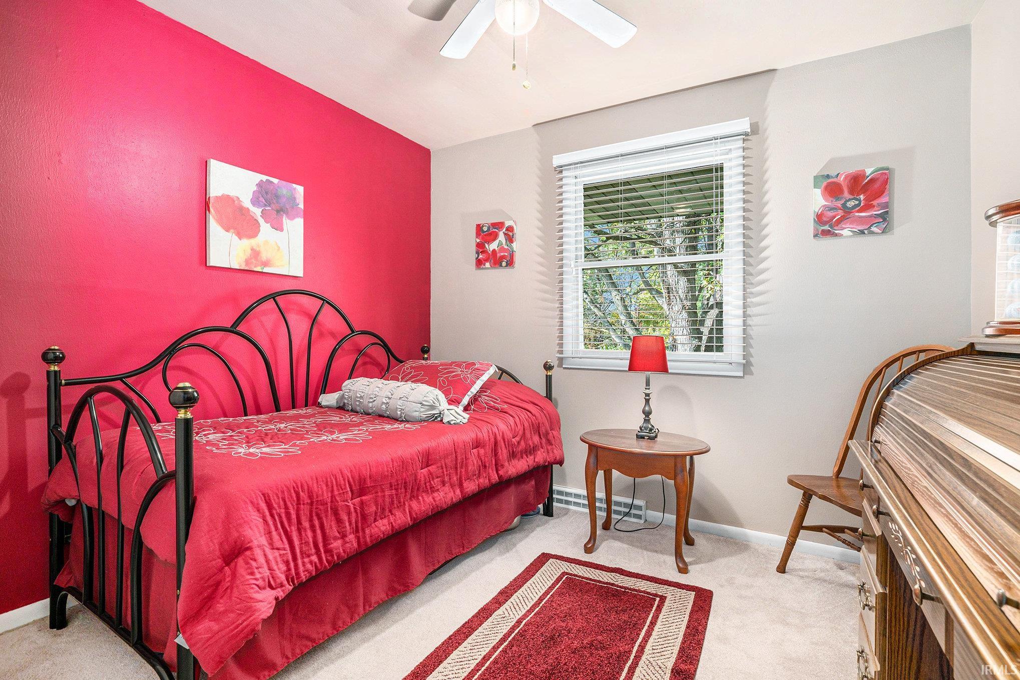 Bedroom featuring light carpet and a ceiling fan