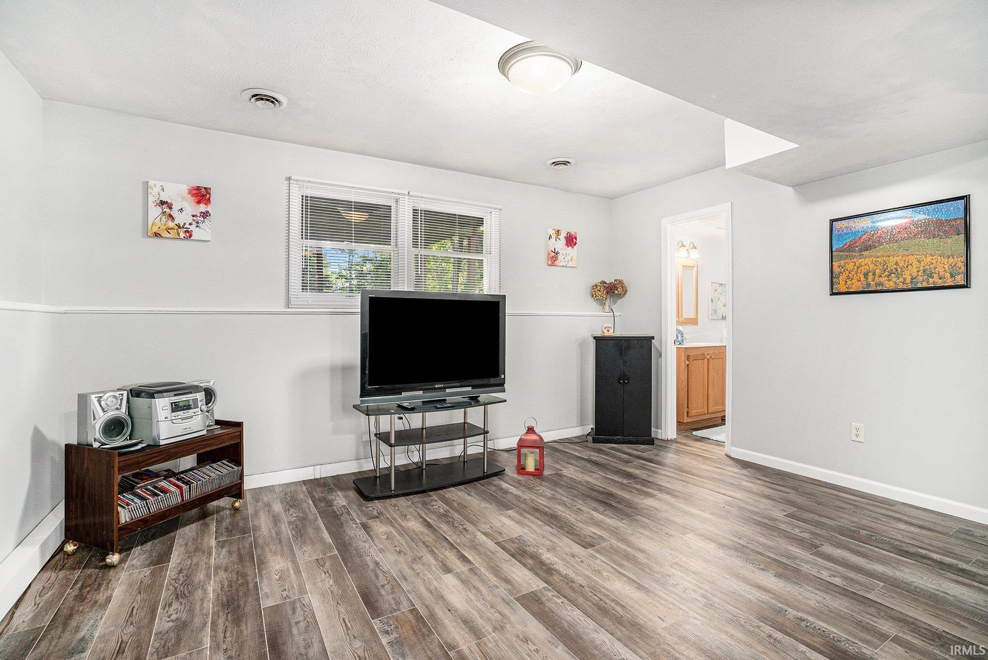 Living room featuring wood finished floors and baseboards