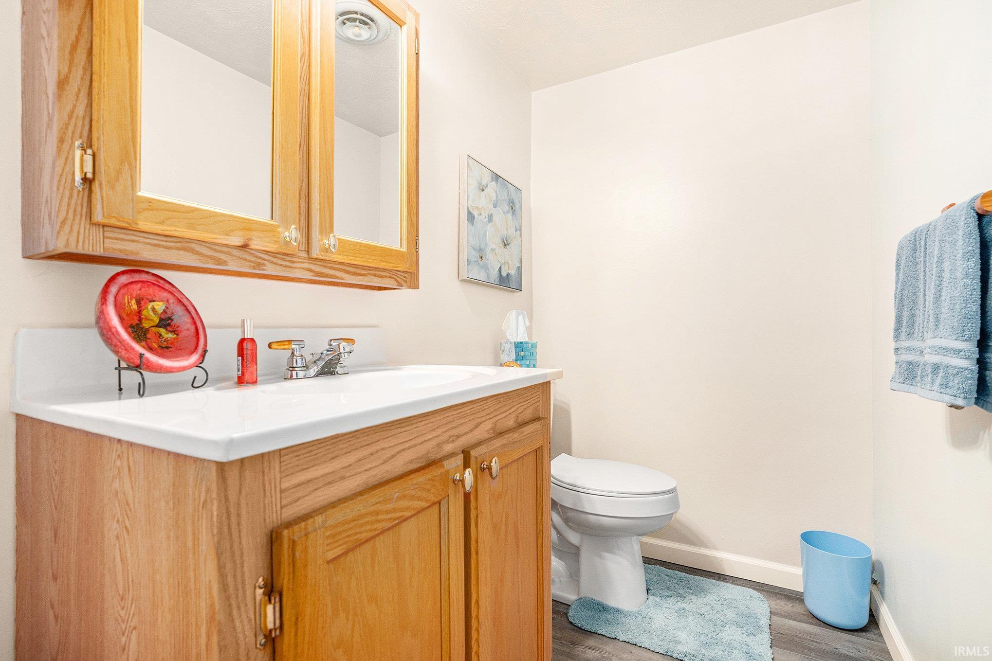 Half bath featuring vanity and light wood-style flooring